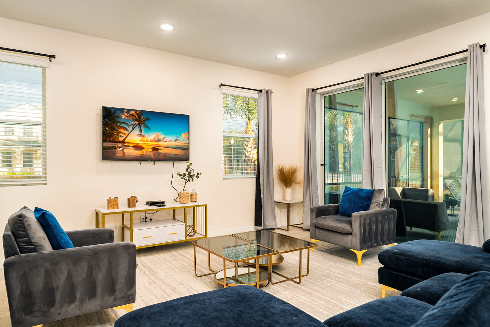 Relax in this stylish living room with plush seating and a large TV, perfect for unwinding after a day of exploring.