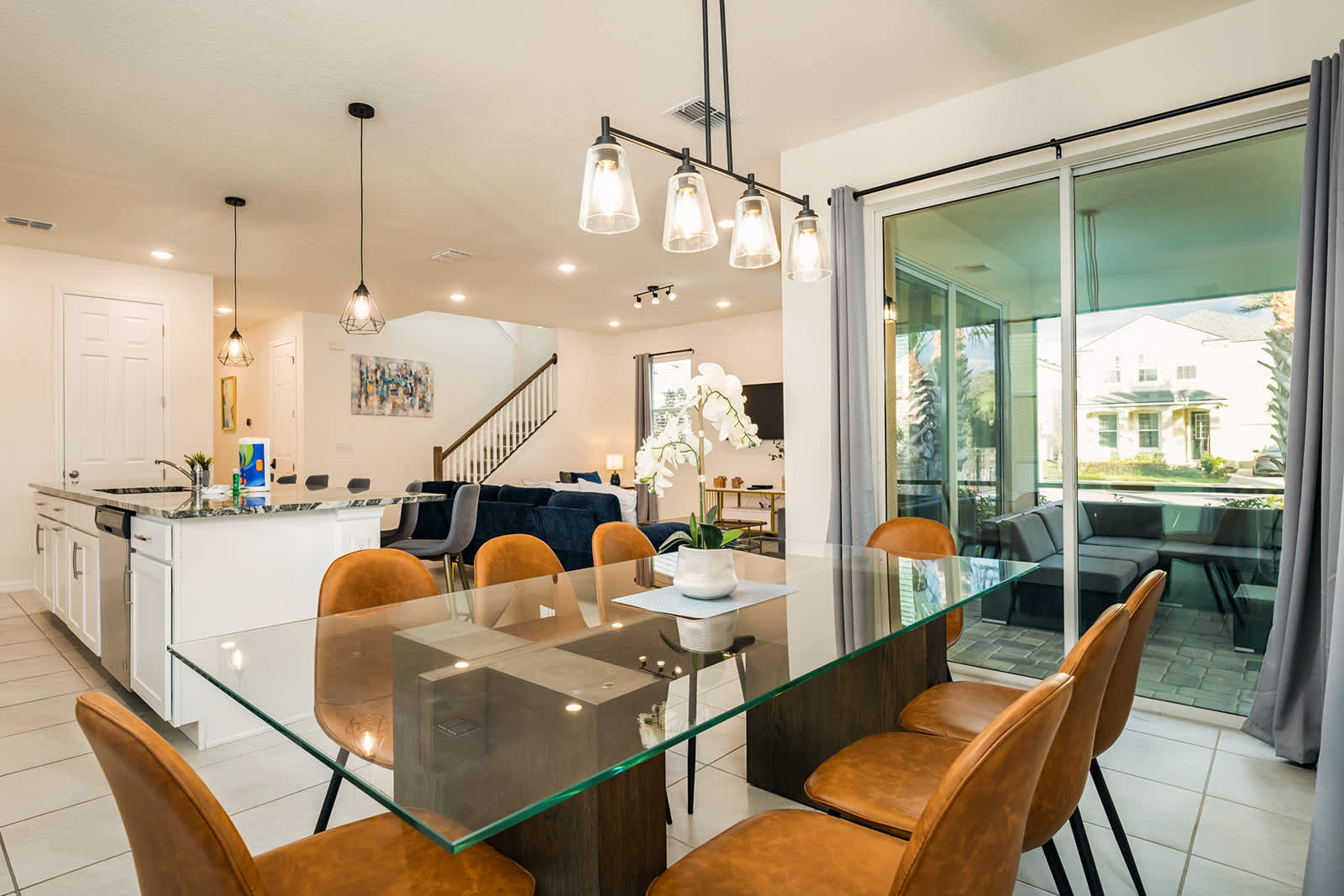 Elegant dining area with seating for eight, perfect for family gatherings, opening to a cozy outdoor patio.