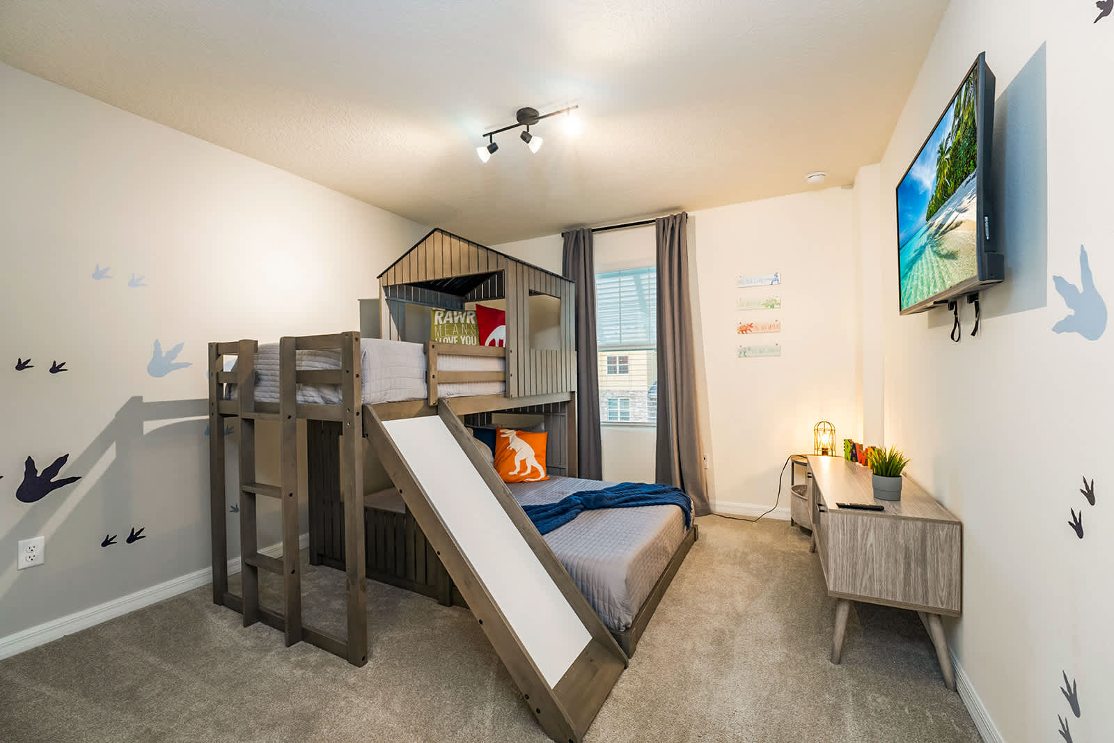 Charming kids' room with a fun bunk bed and slide, perfect for family stays.