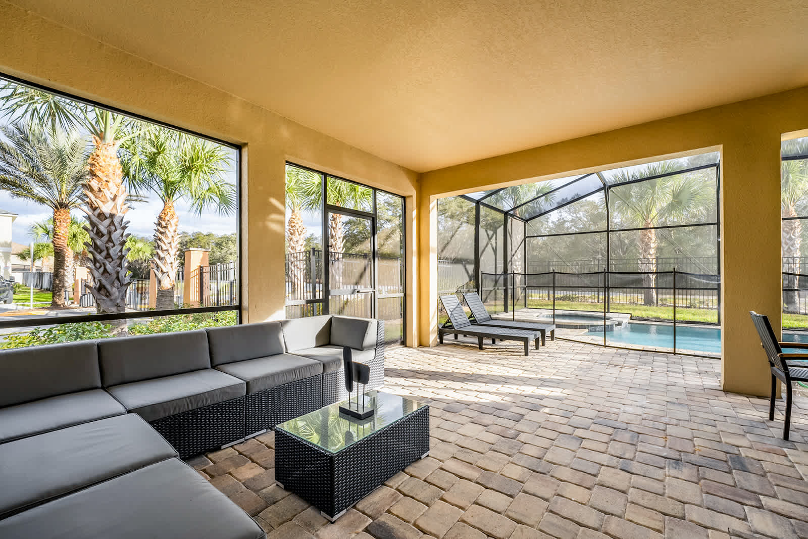 Relax in style on the spacious screened patio with pool views and comfortable seating, perfect for unwinding after a day of adventure.
