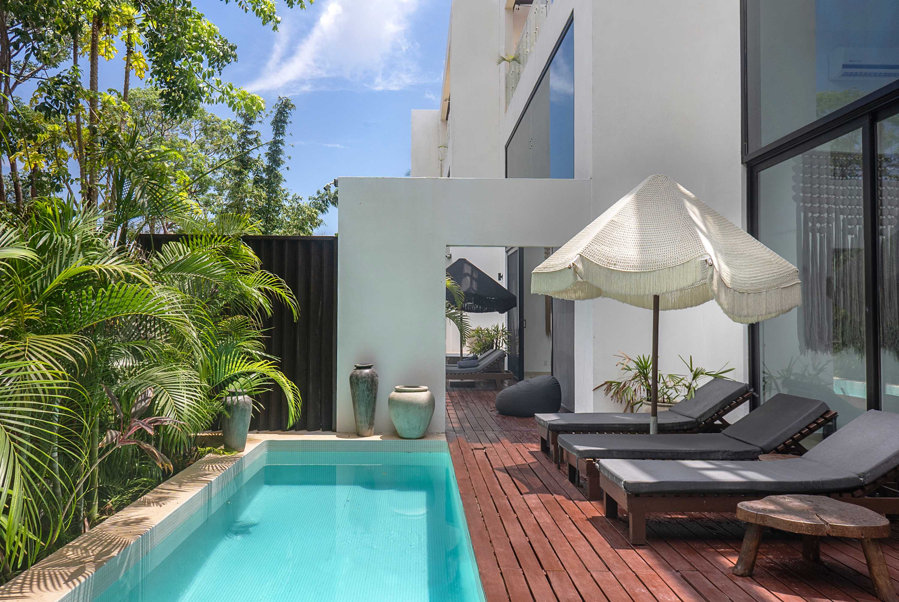 Private pool with a patio door that opens toward the second villa for easy access.