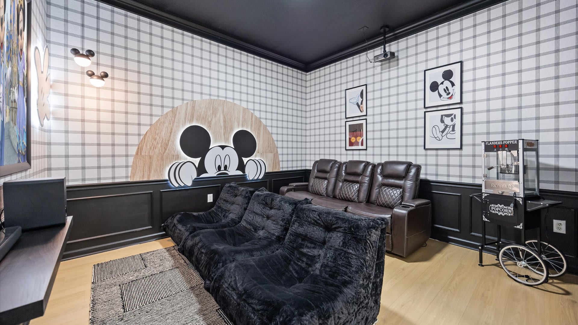 In-home Disney-themed movie room with plush recliners