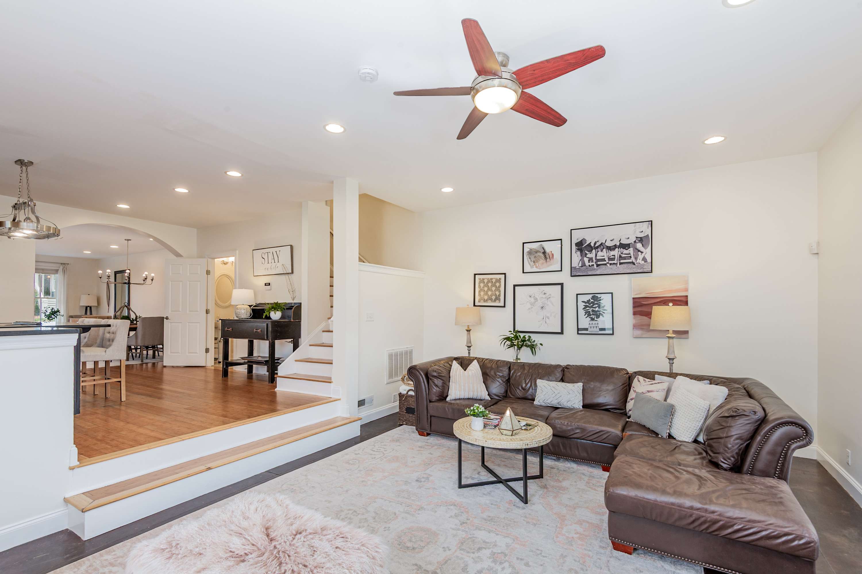 Stylish, open concept living area with fireplace and natural light, perfect for relaxing and entertaining.