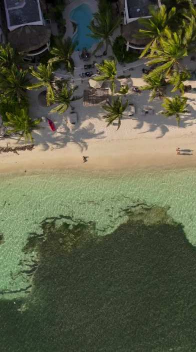 Drone view of the crystal-clear water in front of Mantaray — perfect for snorkeling.