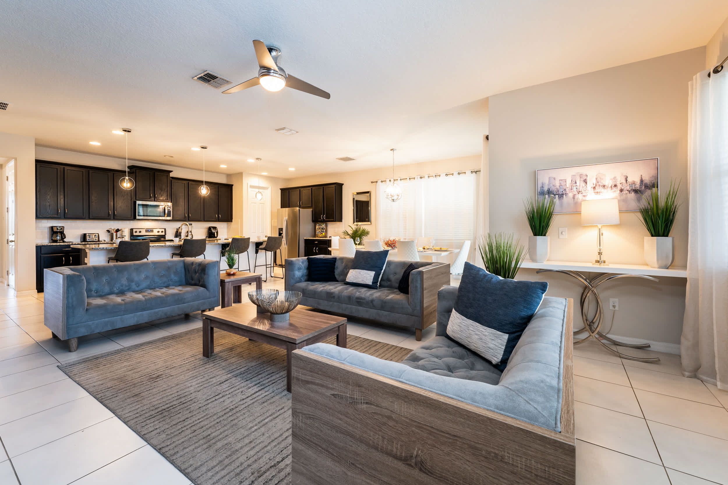 Relax in this elegant open-plan living room with modern comforts and a fully equipped kitchen, ideal for entertaining.