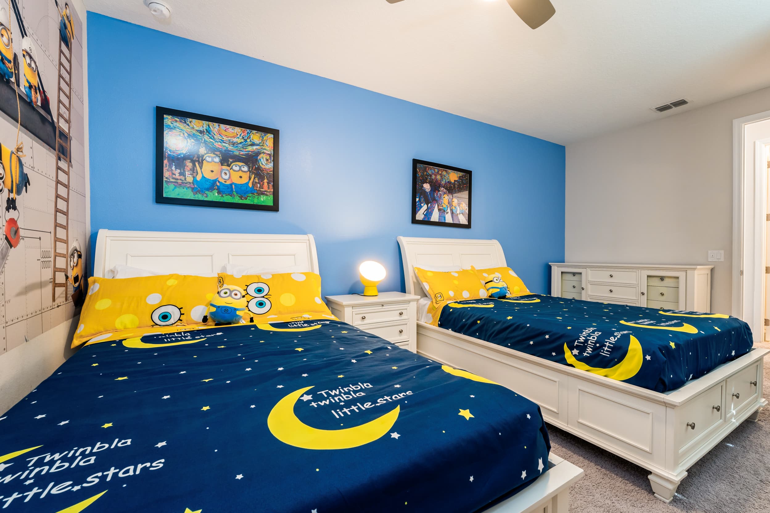 Enjoy a whimsical stay in this Minion-themed bedroom, perfect for kids with twin beds and vibrant decor.