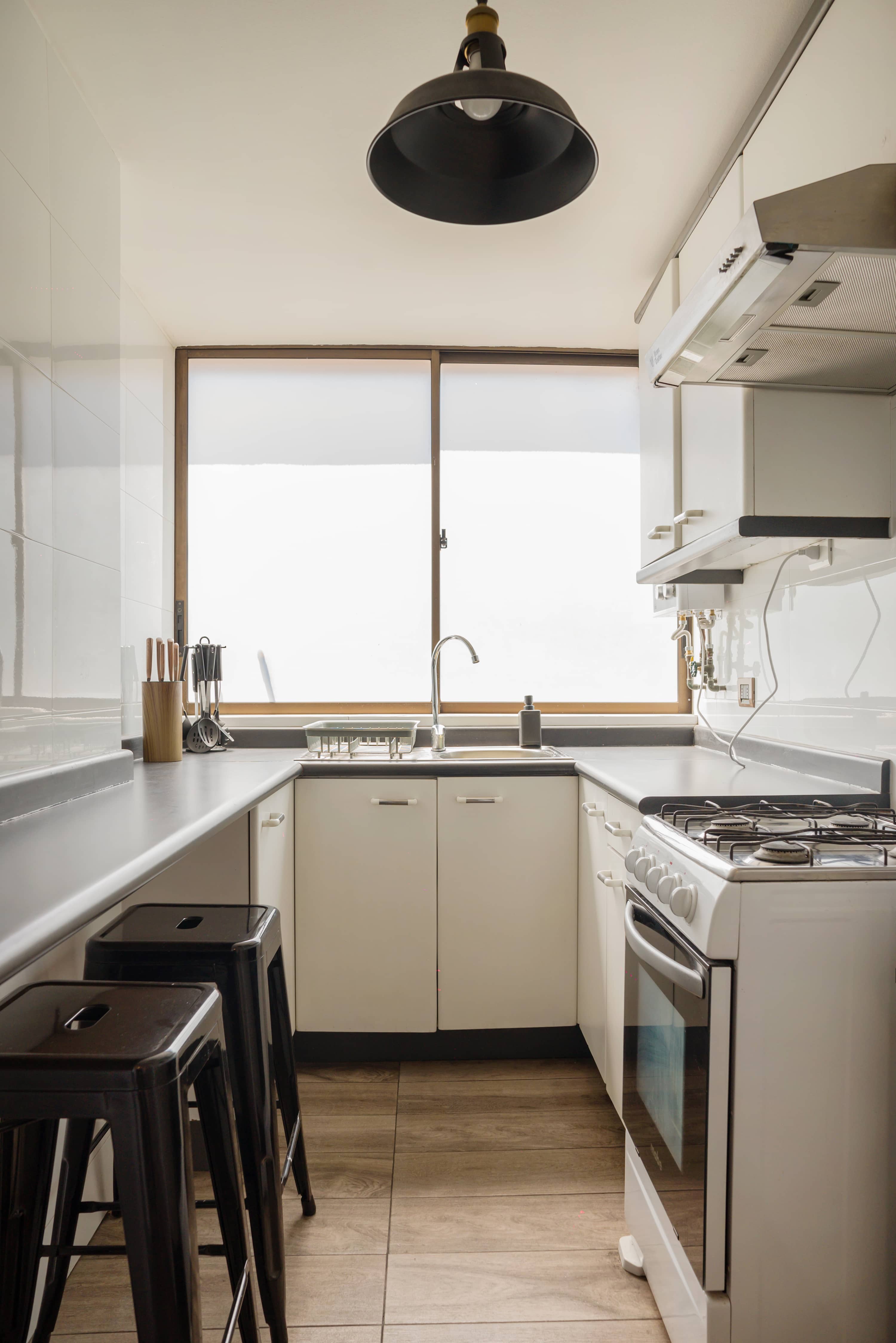 Bright and modern kitchen with ample natural light, perfect for cooking your favorite meals.