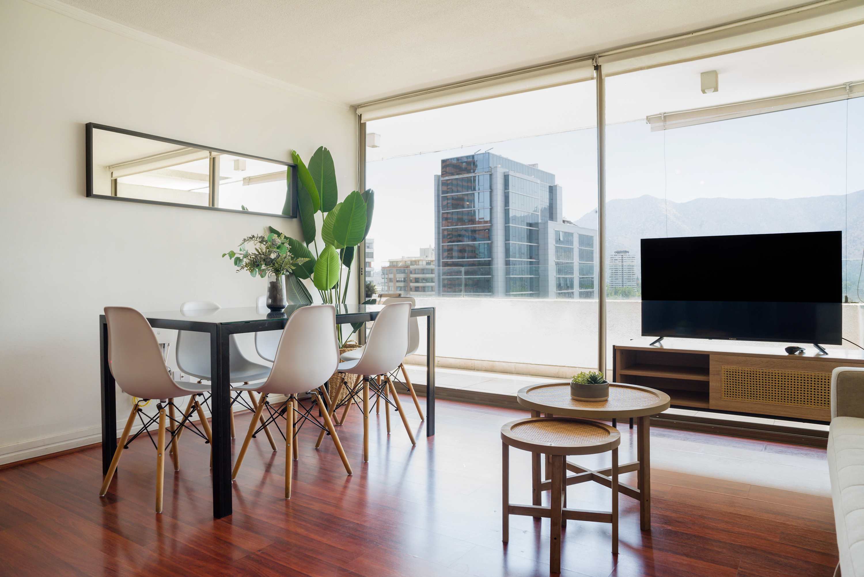 Bright and modern living space with stunning city views, perfect for relaxation and entertainment.