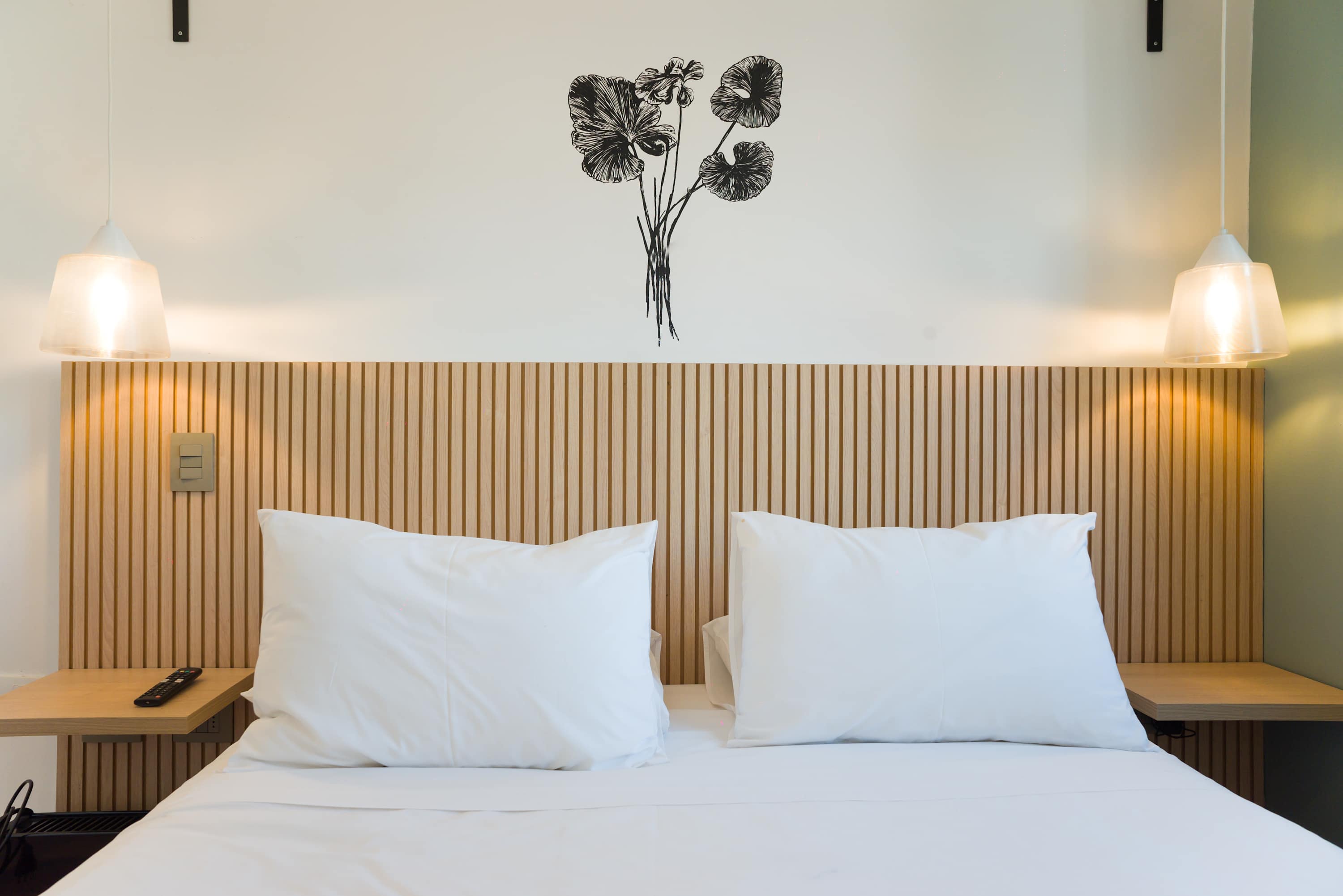 Cozy and modern bedroom with elegant lighting and stylish decor, perfect for a relaxing stay.