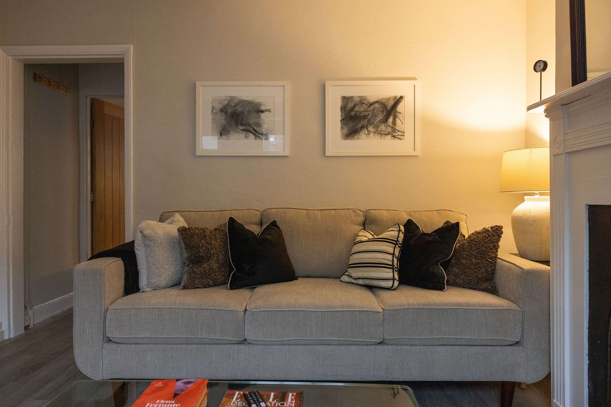 The inviting living area is styled with plush, comfy cushions with soft ambient lamp lighting.