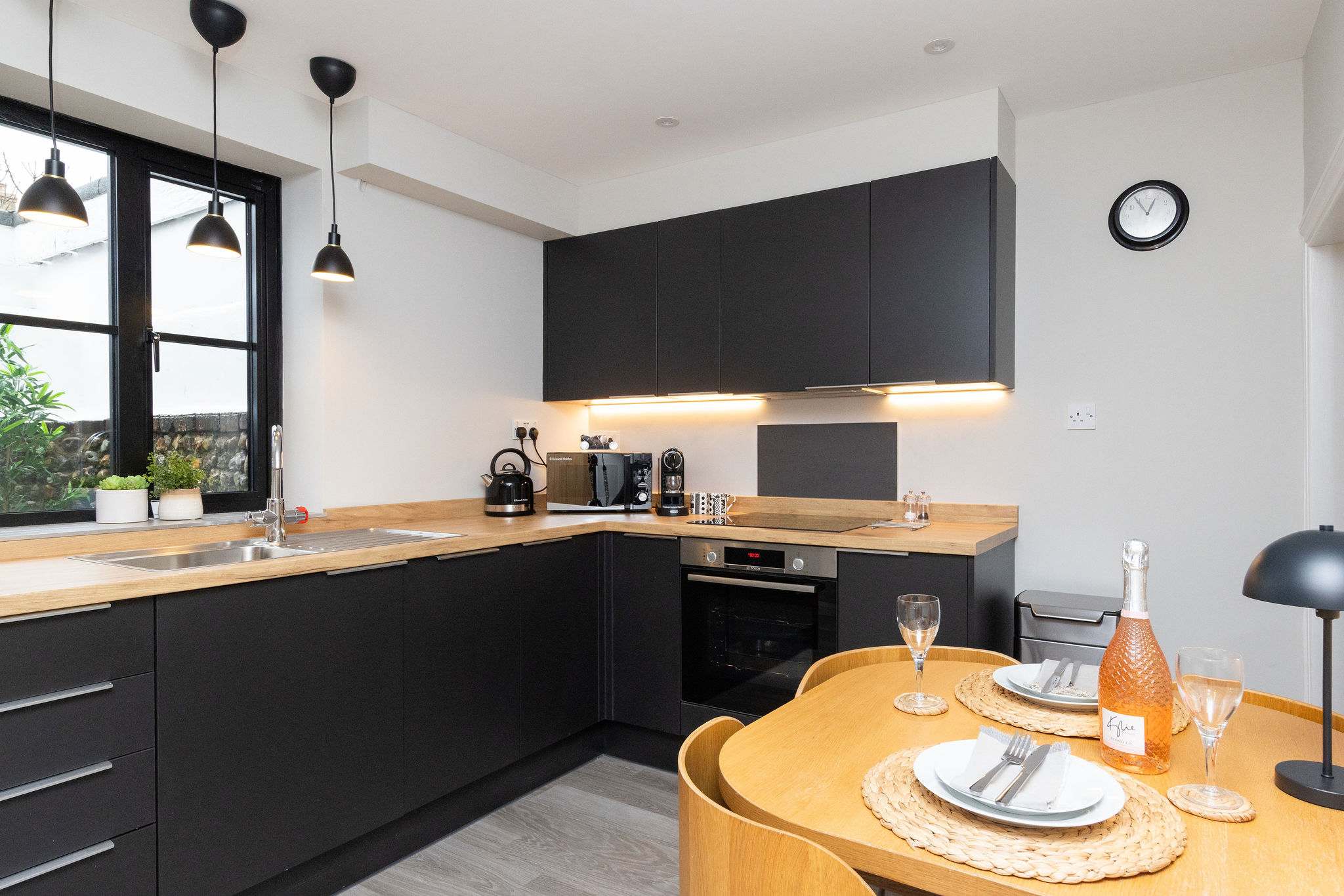 Dark cabinetry with wooden worktops, compliment each other perfectly.