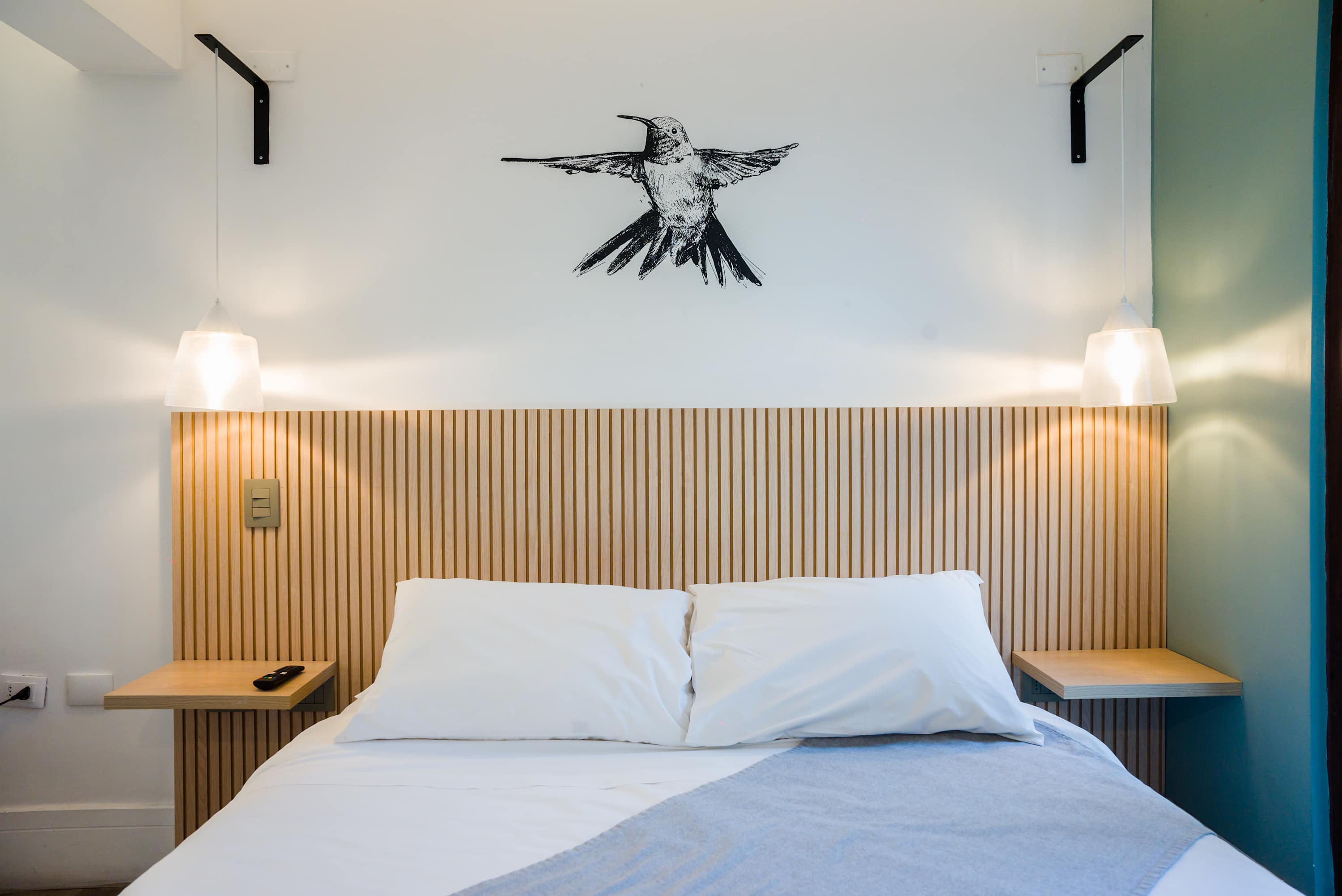 Cozy studio bedroom with modern decor and ambient lighting, perfect for a relaxing stay.