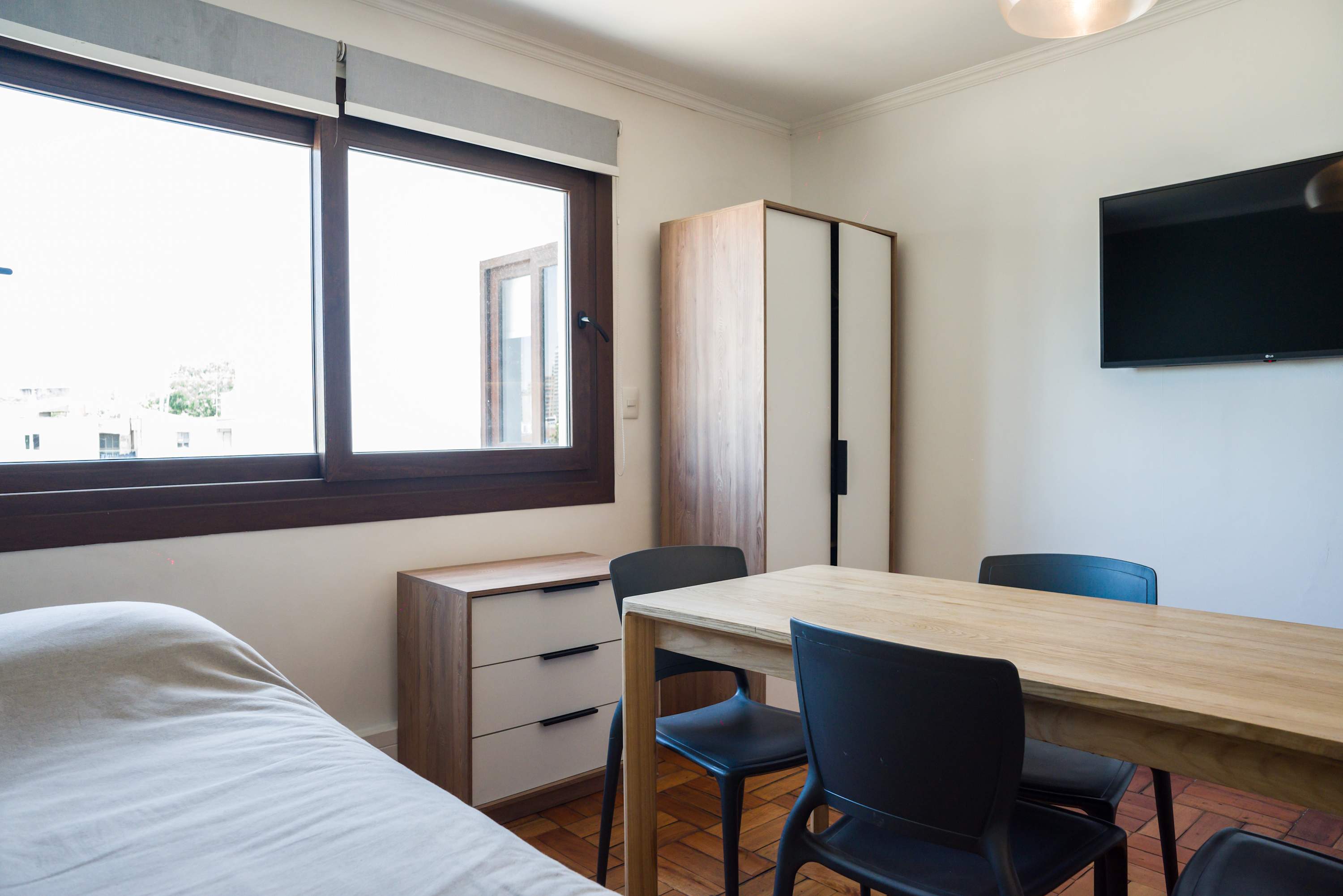 Cozy living area with ample natural light, perfect for relaxation or work.