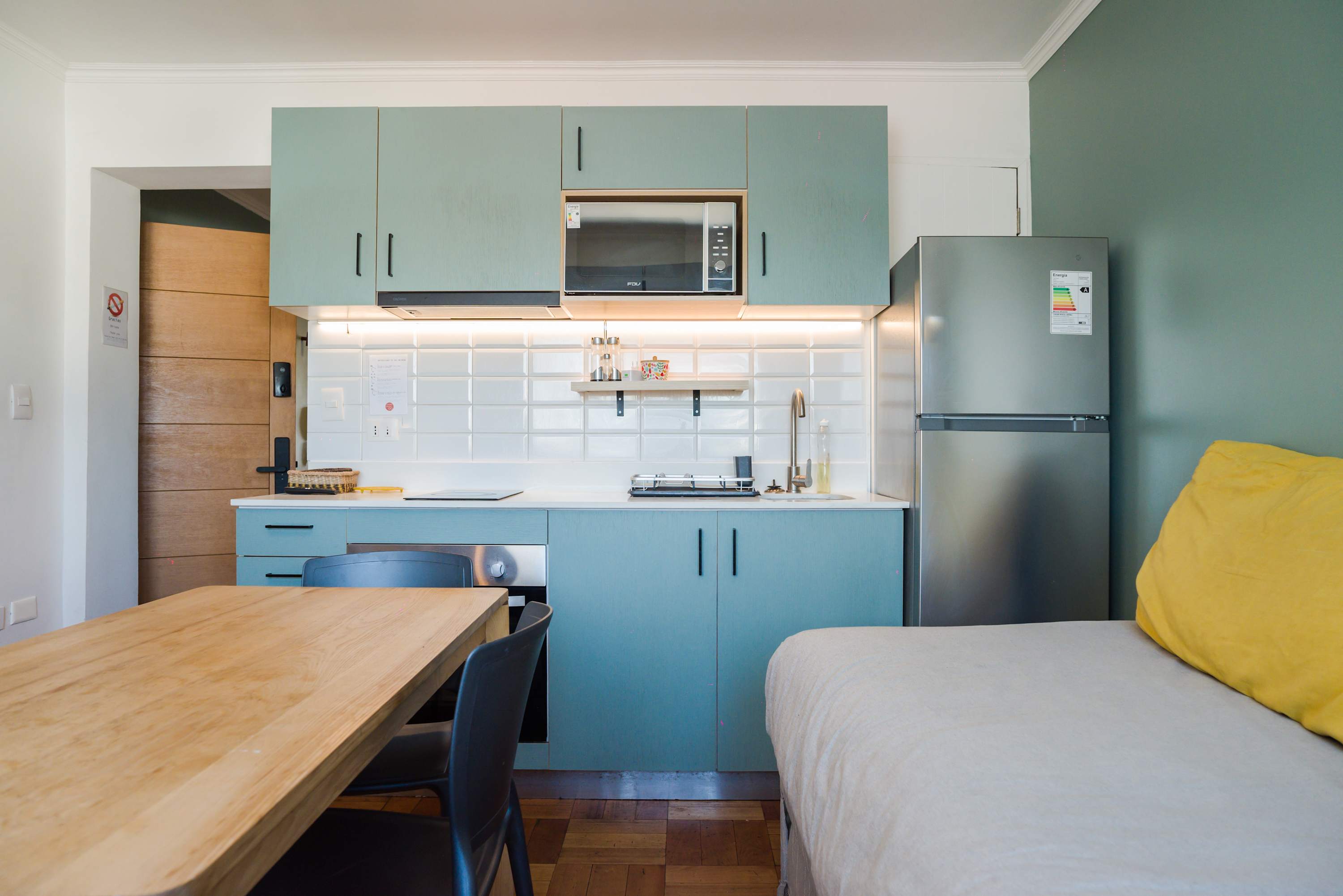 Charming studio kitchen with modern amenities and cozy dining area, perfect for a comfortable stay in Chile.