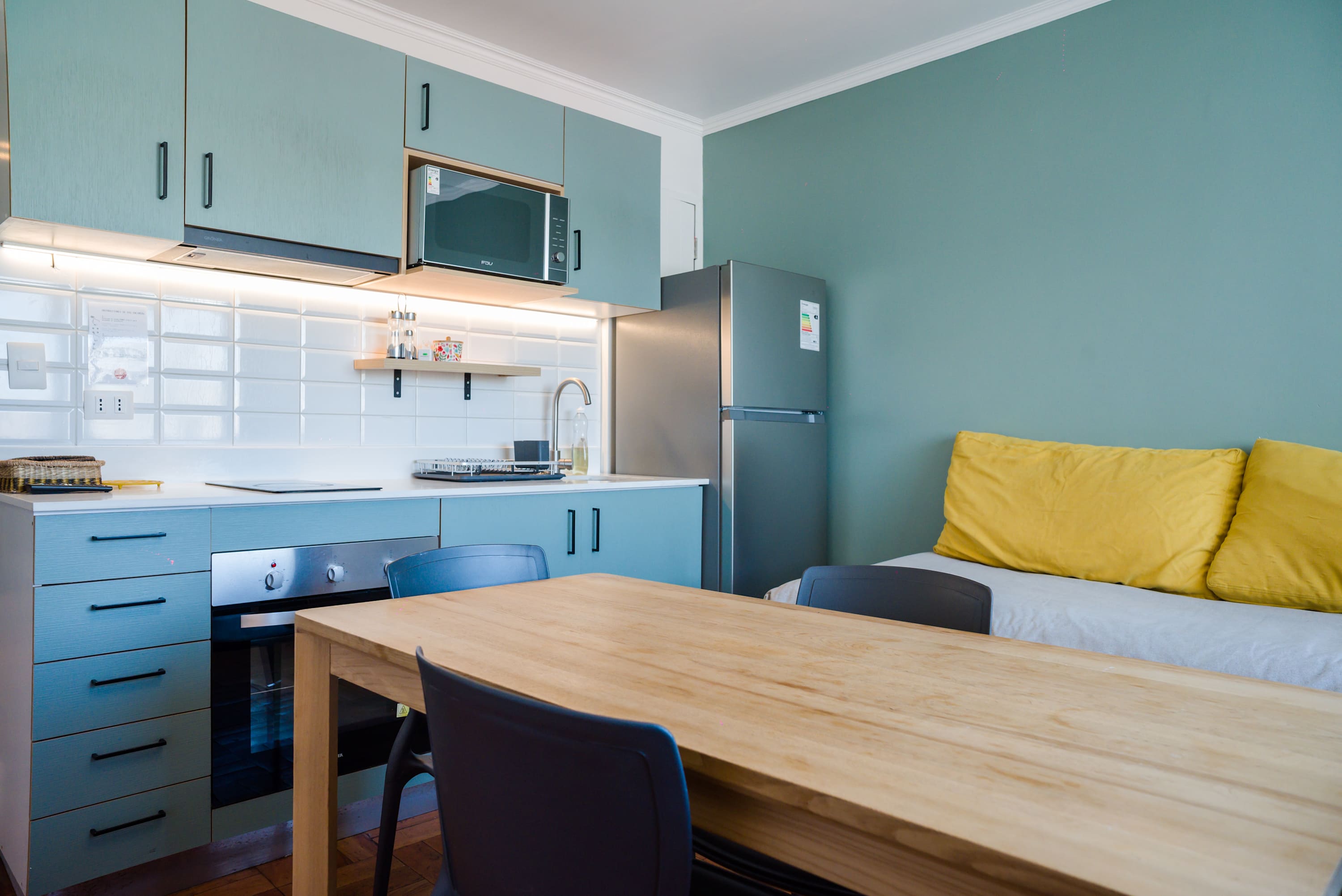 Modern kitchen with dining area and cozy seating, perfect for a comfortable stay.