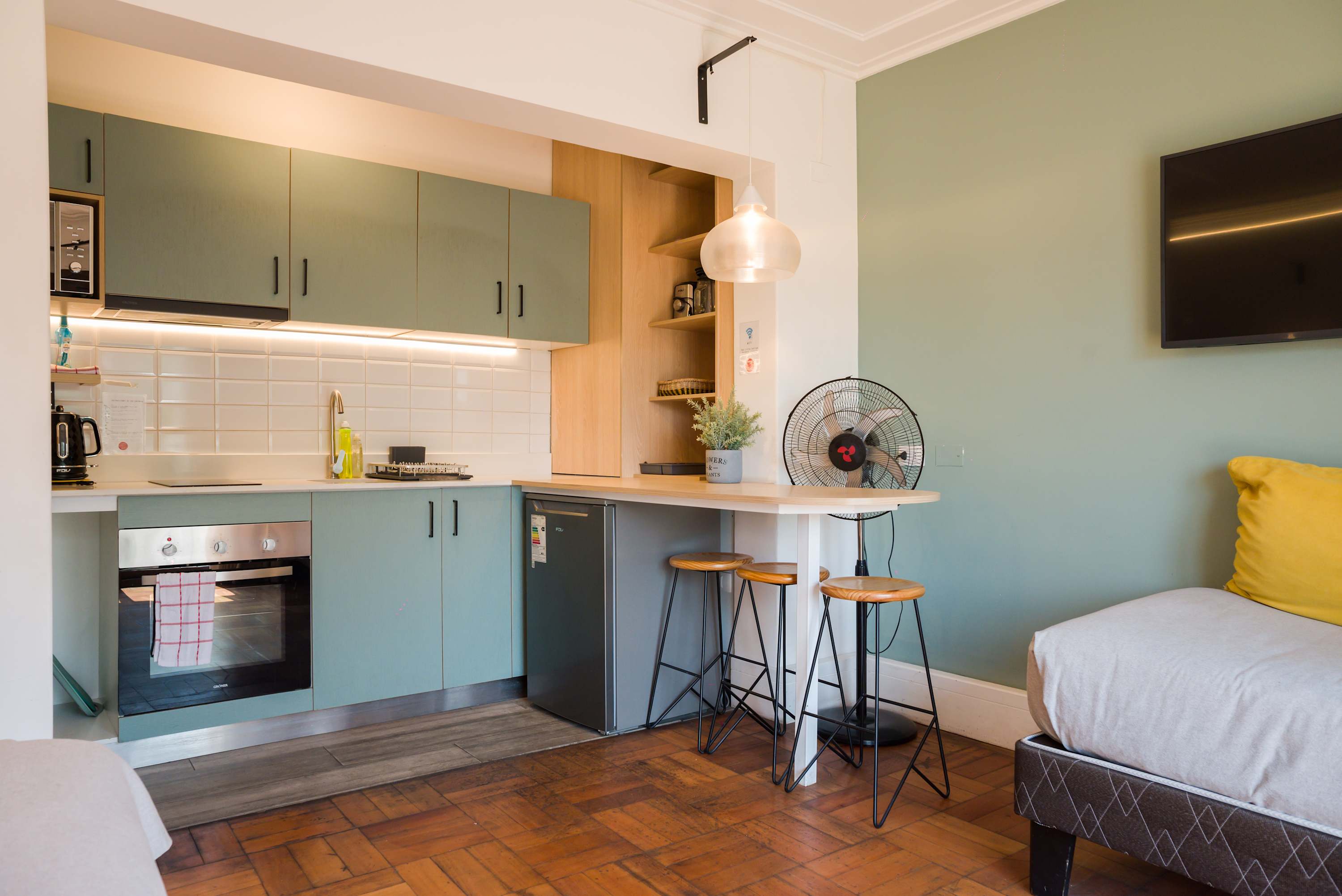 Charming studio kitchen with modern amenities and cozy seating, perfect for a relaxing stay.