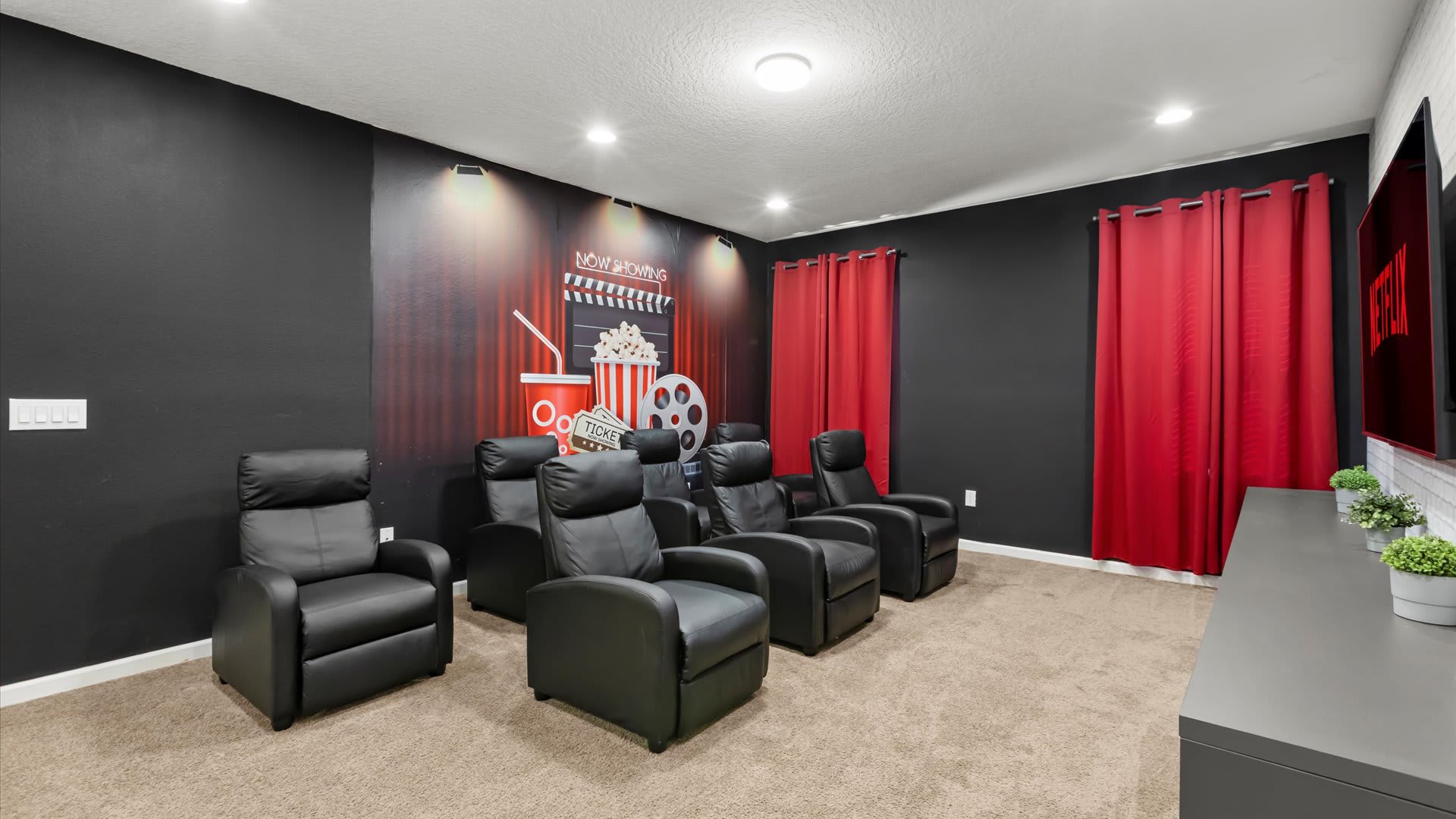 Private in-home cinema with plush recliners and a large screen.