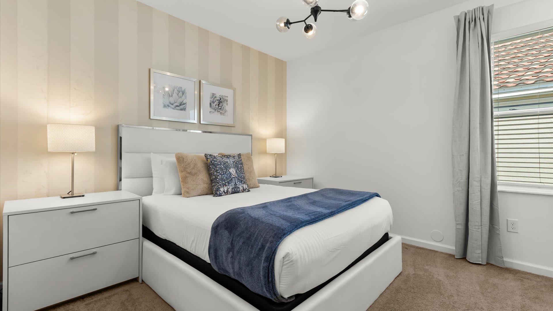 Minimalist queen bedroom with plush bedding.