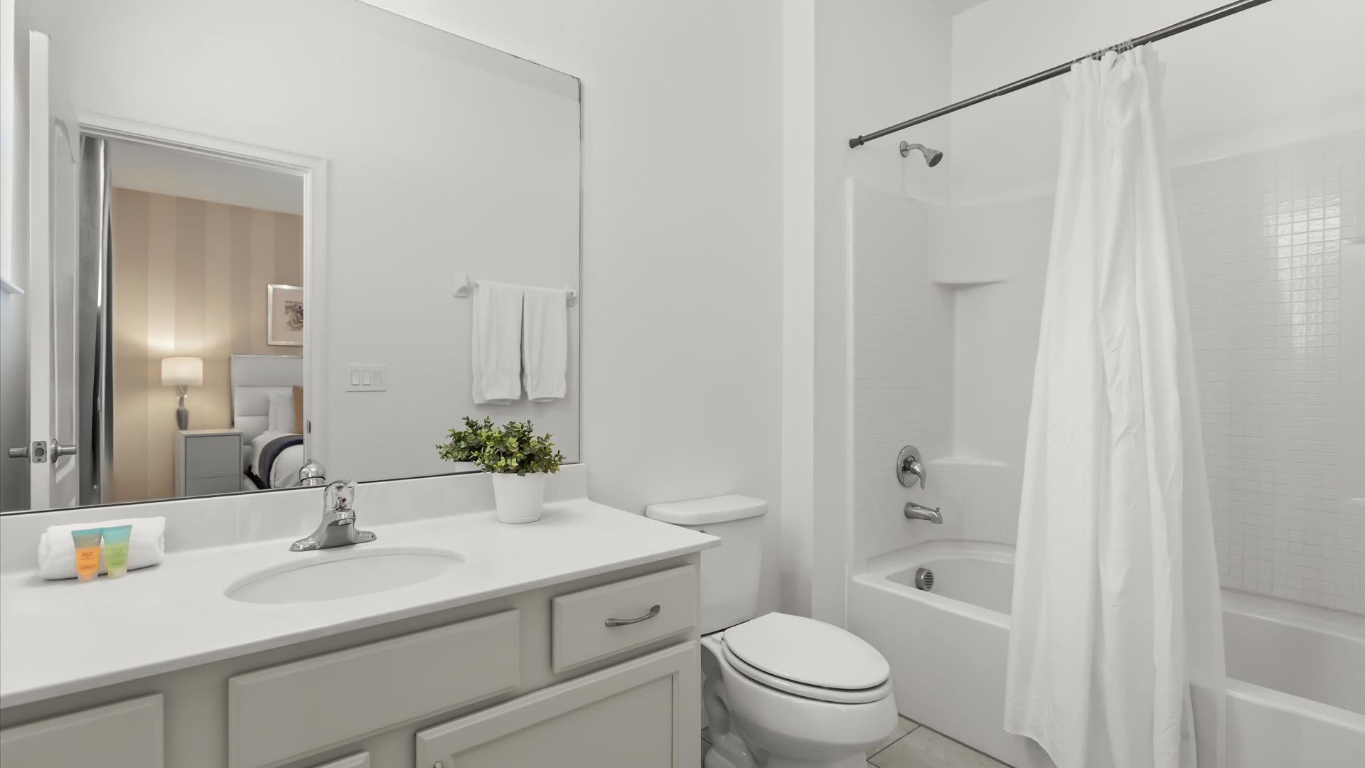 Ensuite bathroom with spacious vanity and bright lighting.