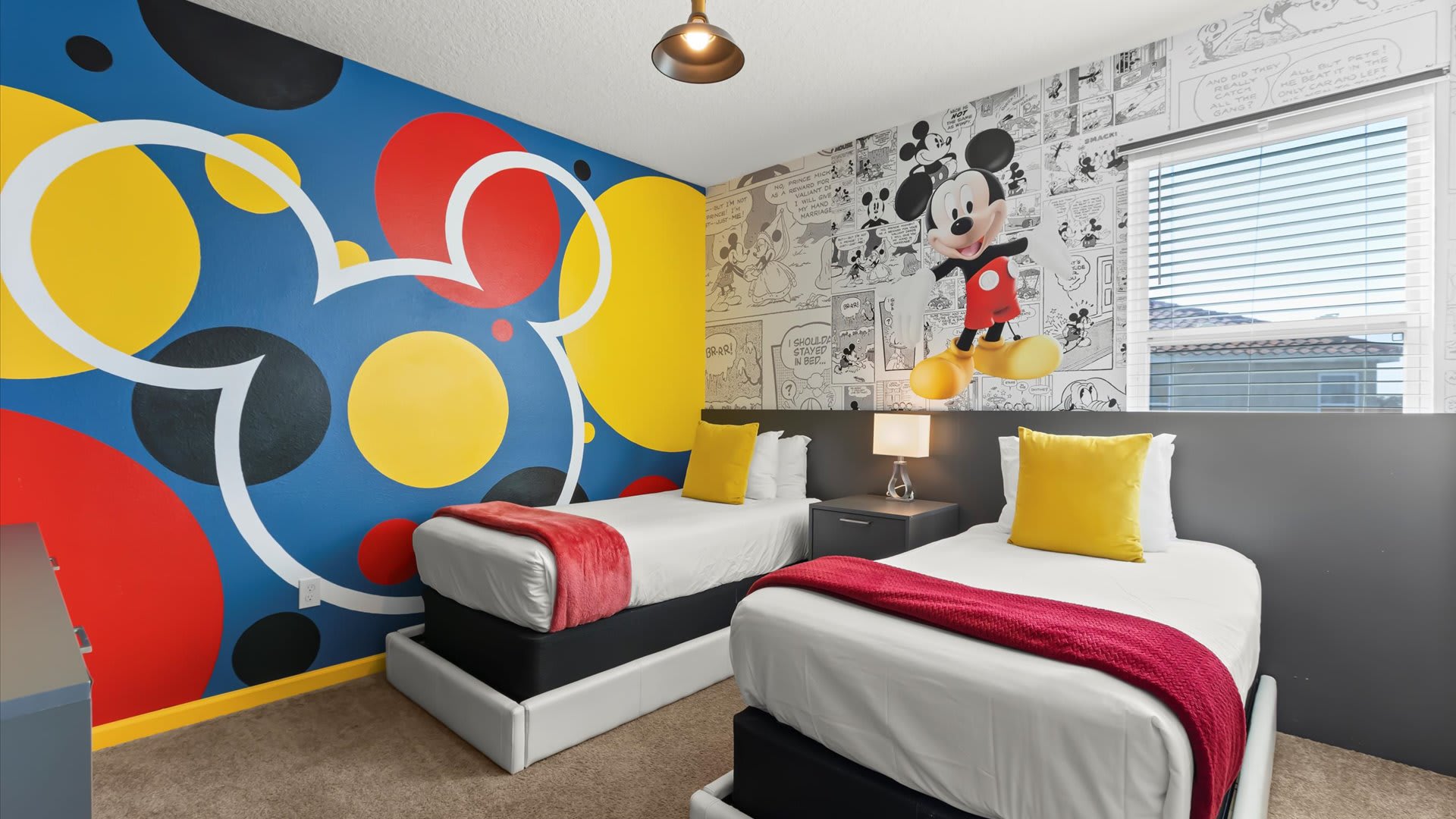 Mickey Moused themed kids’ twin room with TV and playful wall art.