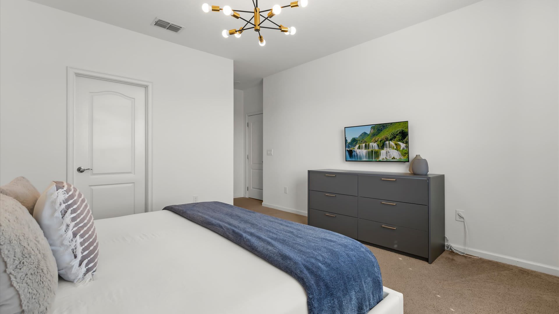 Bright King bedroom with ample natural light.