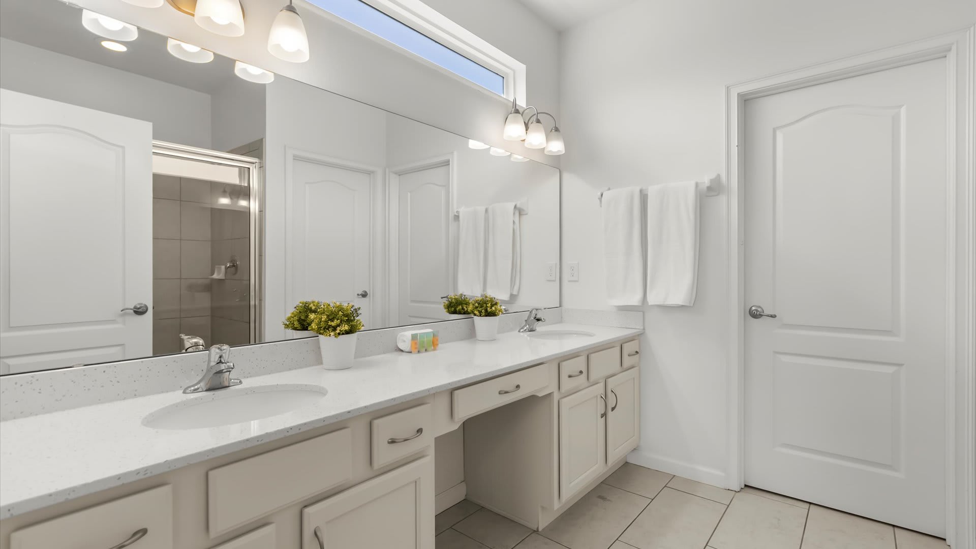 Large ensuite bathroom with dual sinks.