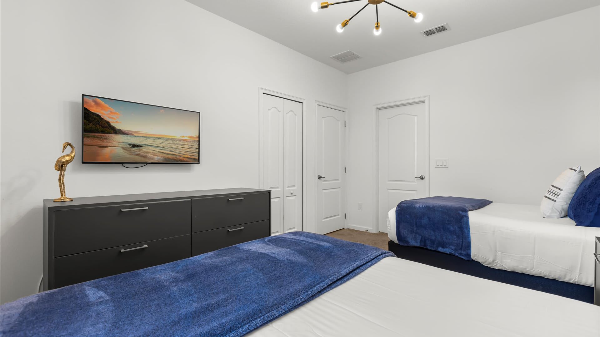 Calming twin bedroom with soft décor and natural light.