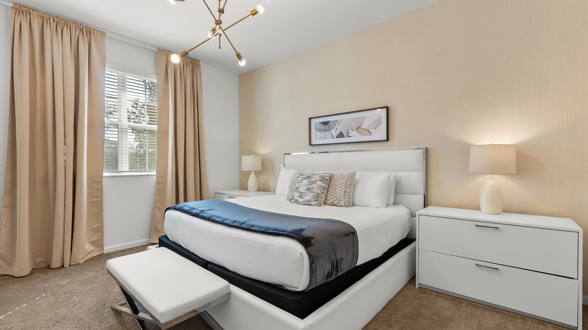 Warm queen bedroom accented with golden drapery.