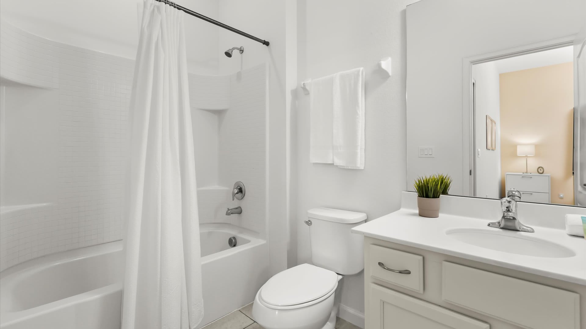 Ensuite bathroom with shower + tub combo.