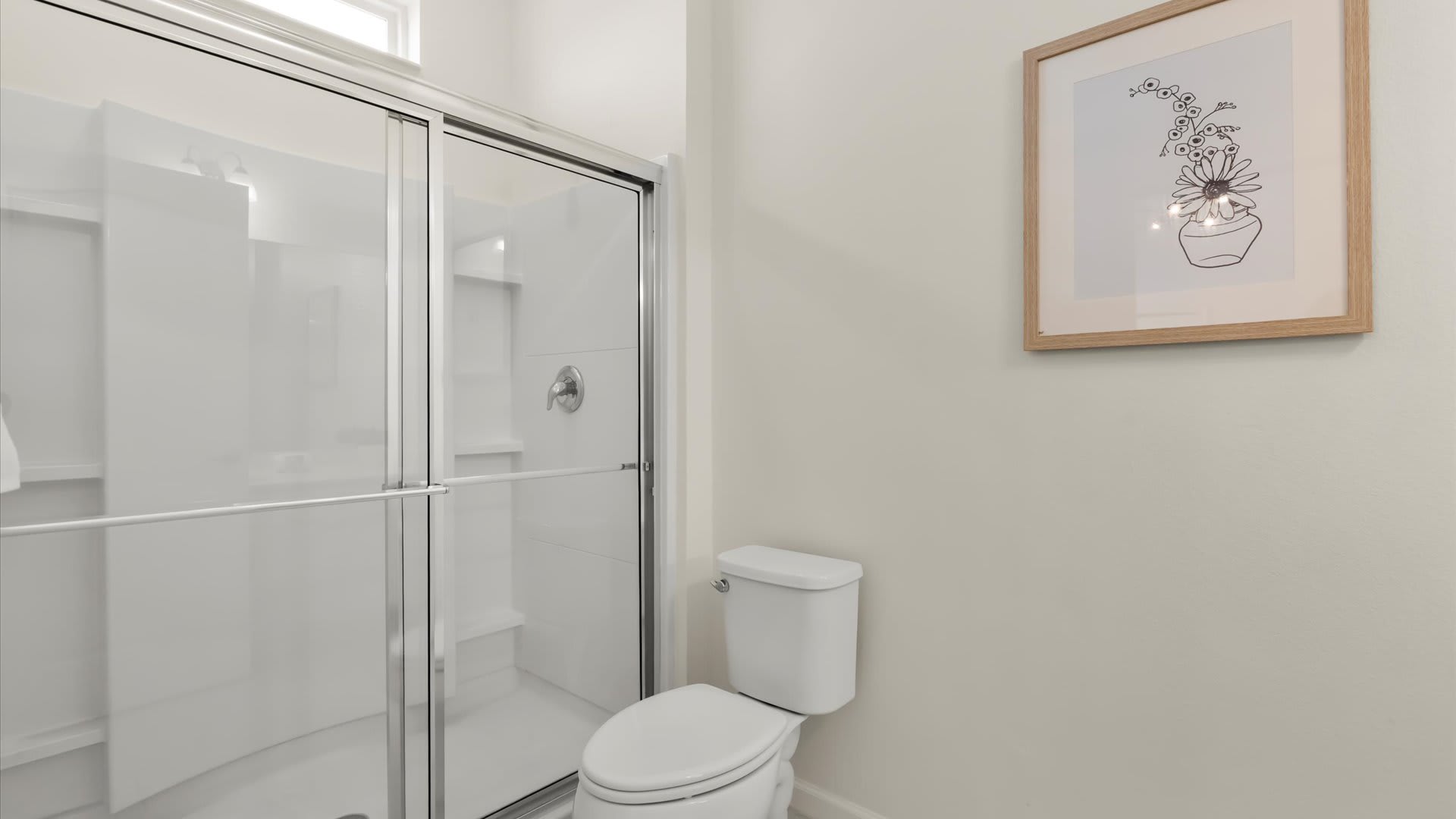 Standing shower in ensuite bathroom.