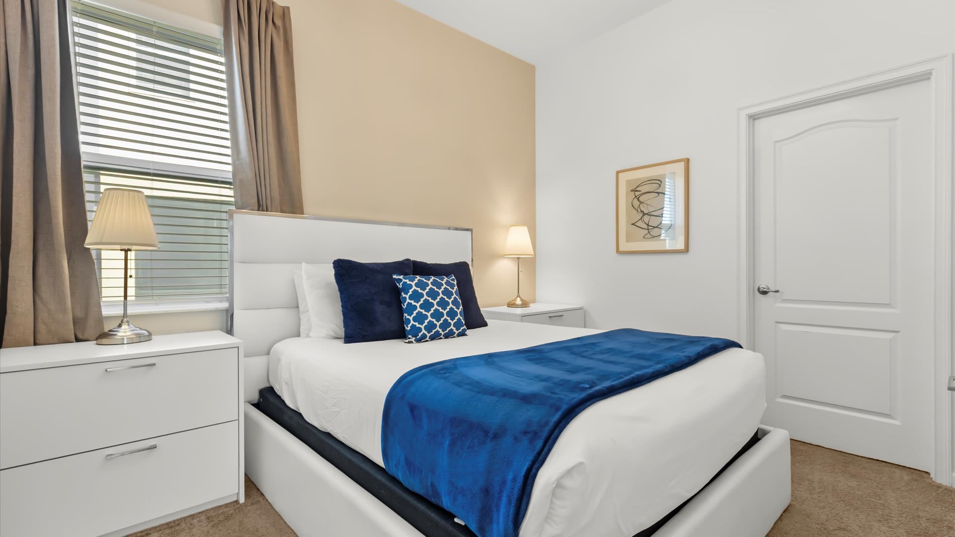 Deep blue queen bedroom with sleek modern furniture.
