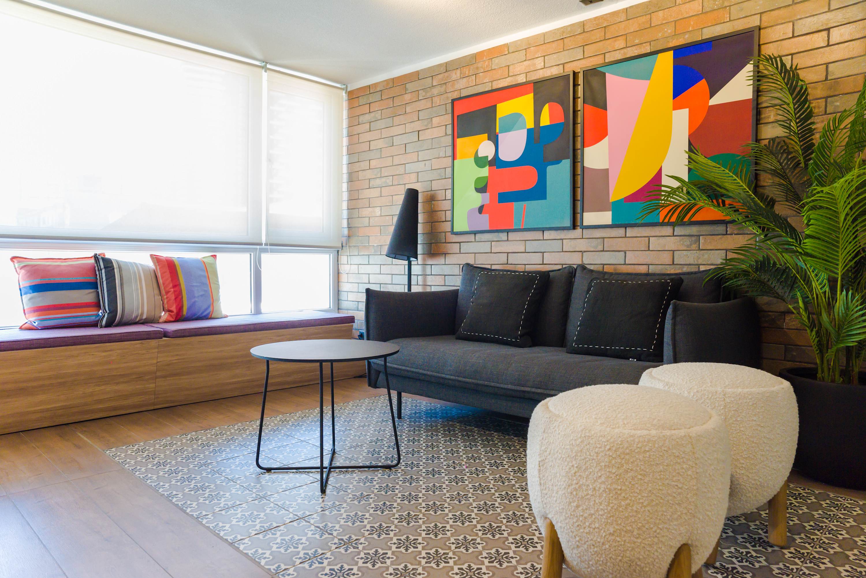 Chic living area with vibrant art and cozy seating, perfect for relaxation in a stylish setting.