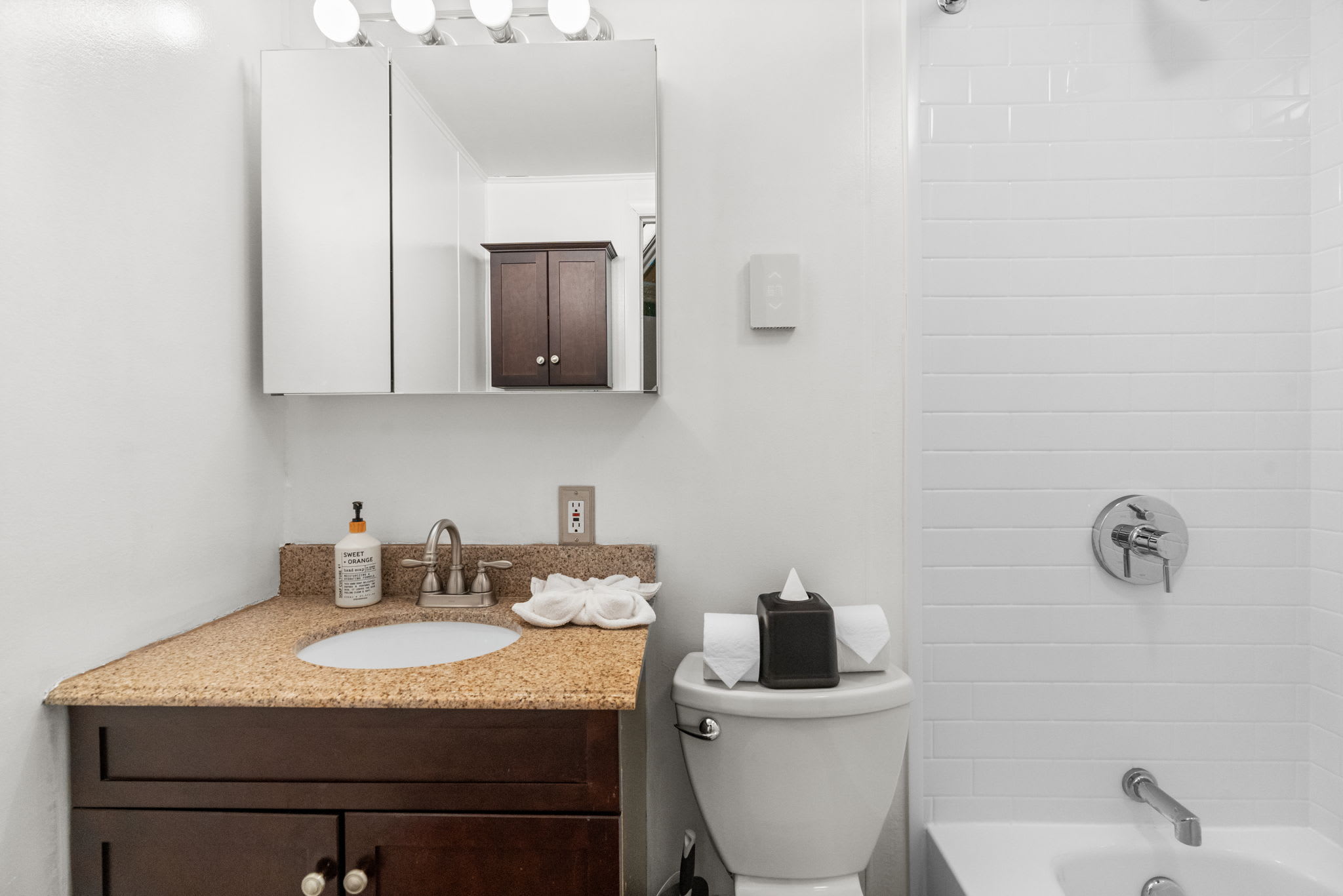 Charming bathroom with rustic wood vanity and cabin-style fixtures at Lake Naomi retreat