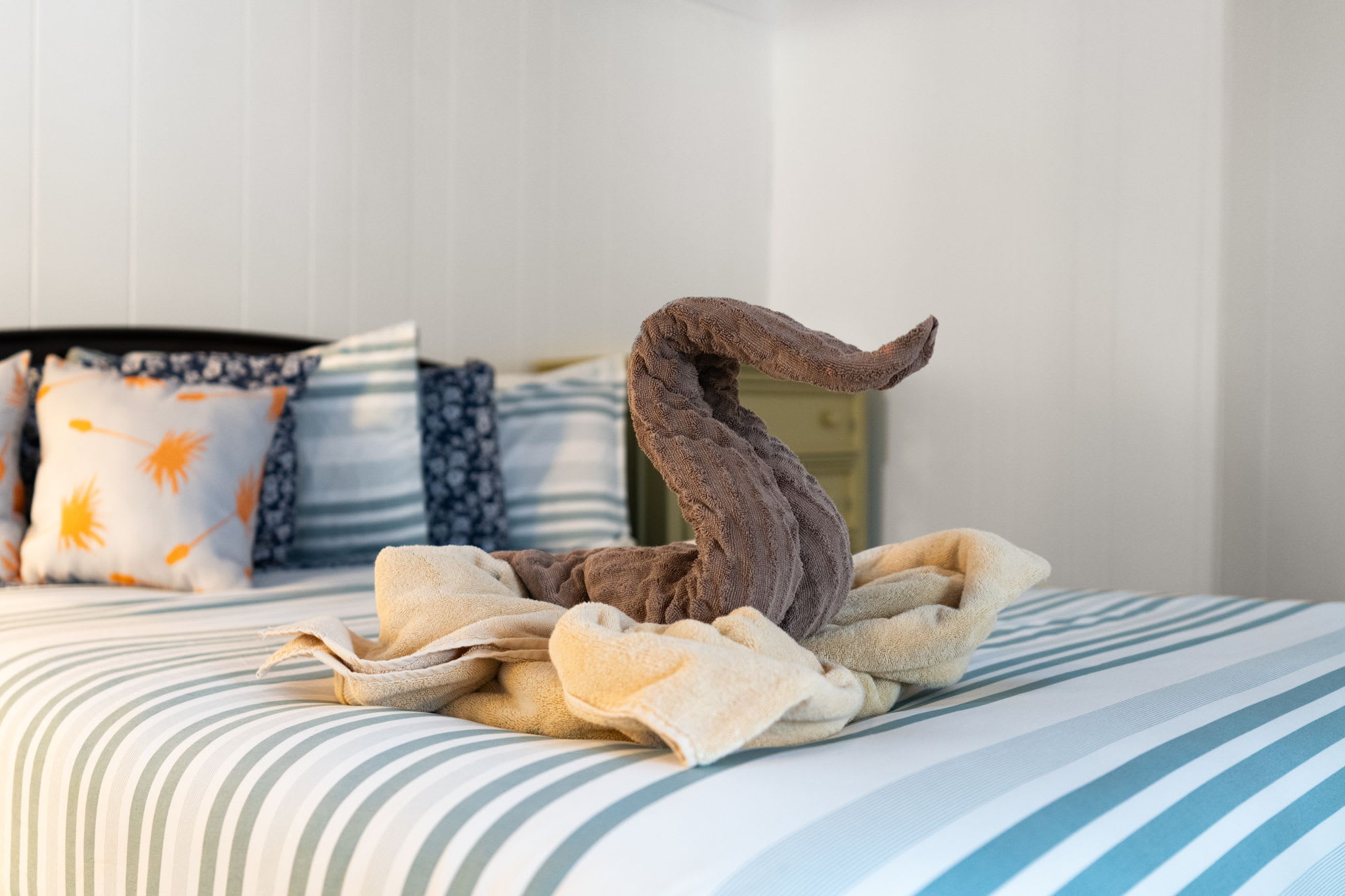 Cozy bedroom with nautical striped linens and vintage decor at Pocono Mountains cabin