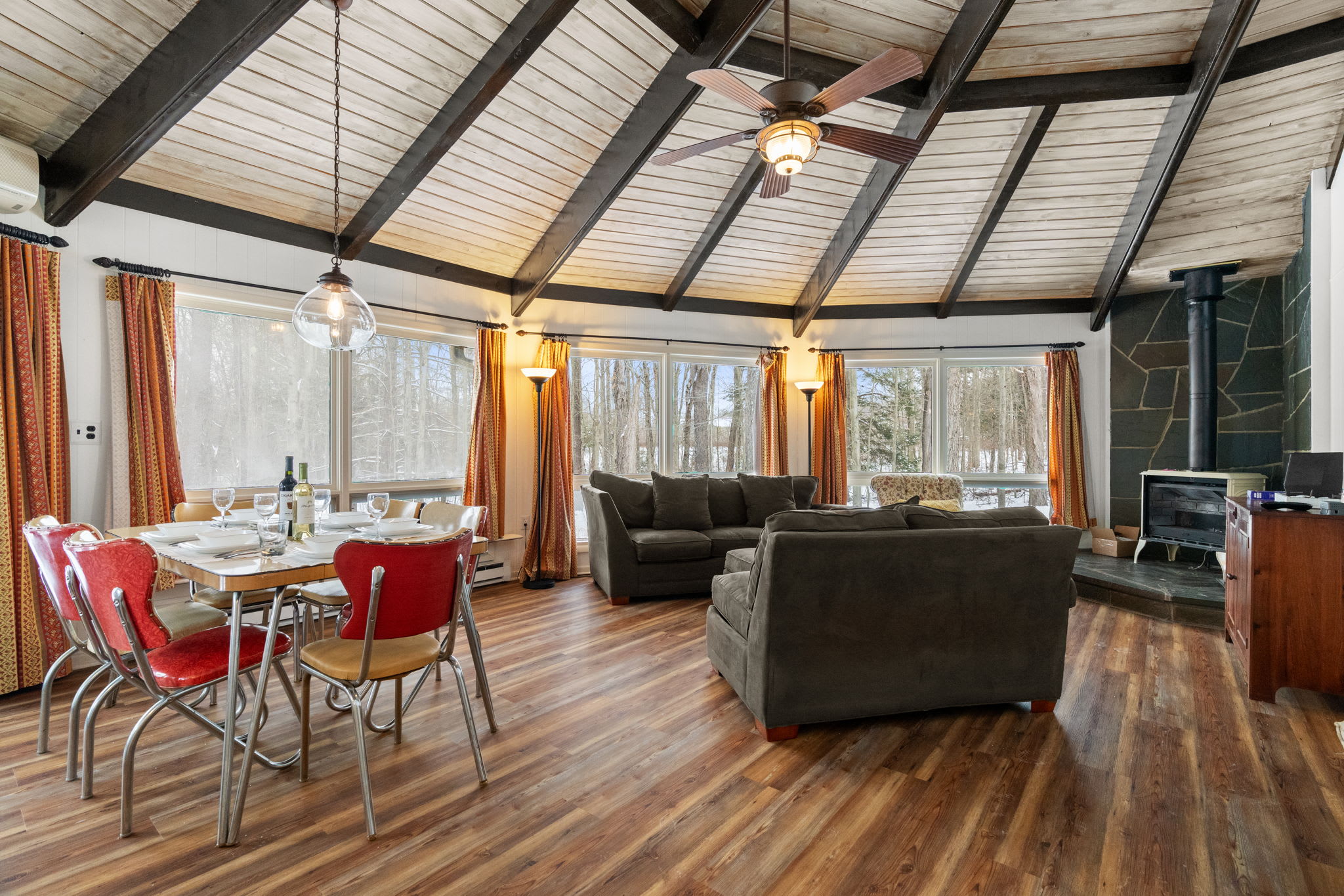 Soaring  ceiling with exposed wooden beams in spacious Lake Naomi cabin living area