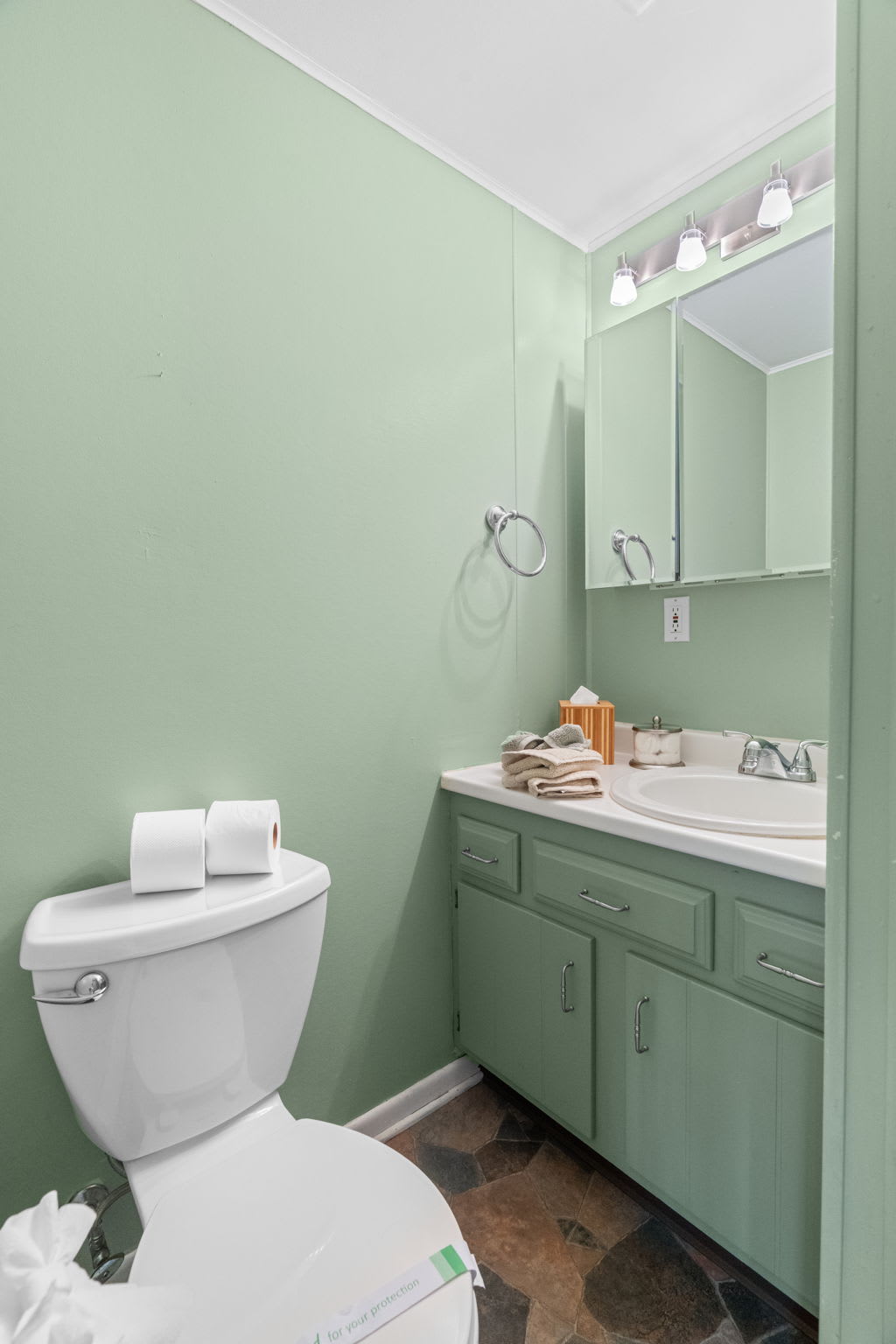 Vintage-style second bathroom with classic green tile in Pocono Mountains vacation cabin