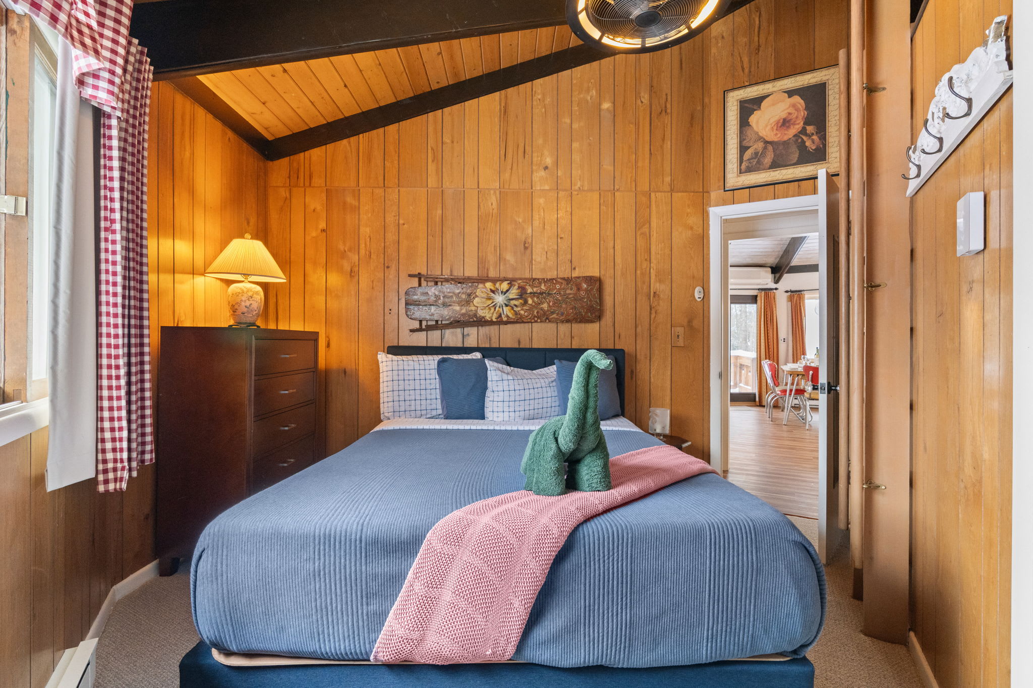 Charming loft bedroom with double bed and exposed wood beams at Lake Naomi cabin