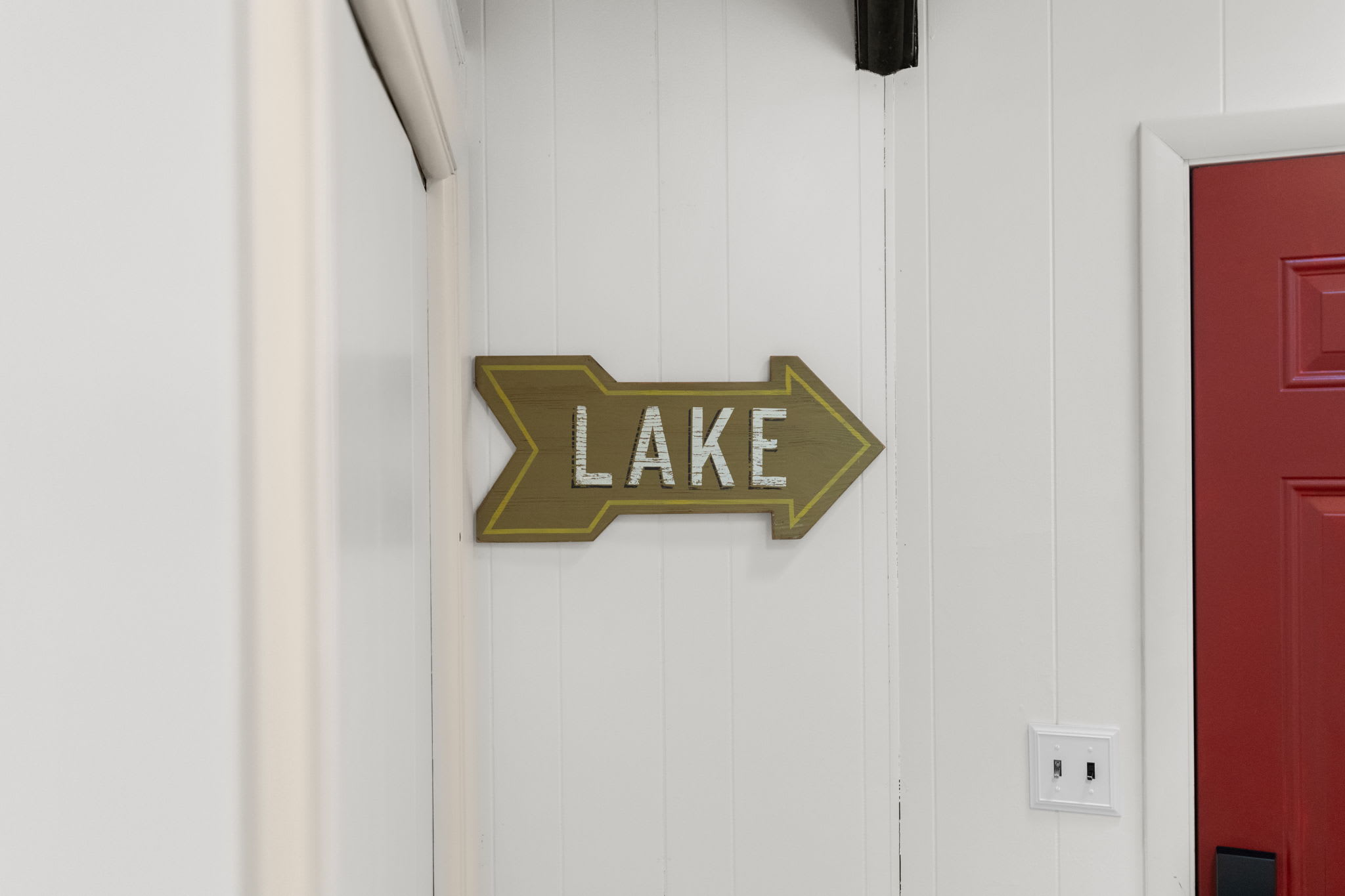 Decorative LAKE sign adding rustic Pocono Mountains charm to the cabin interior