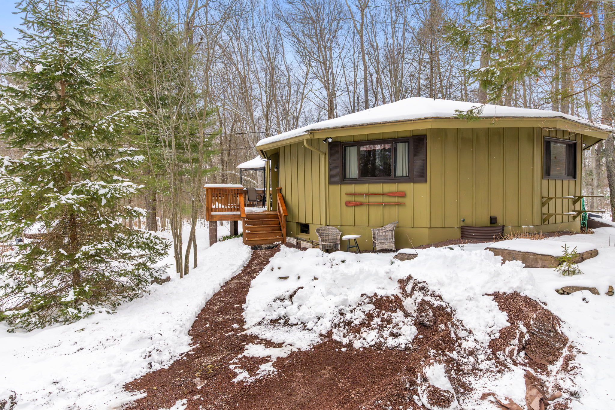Charming cabin exterior surrounded by winter snow in Lake Naomi community Pocono Mountains