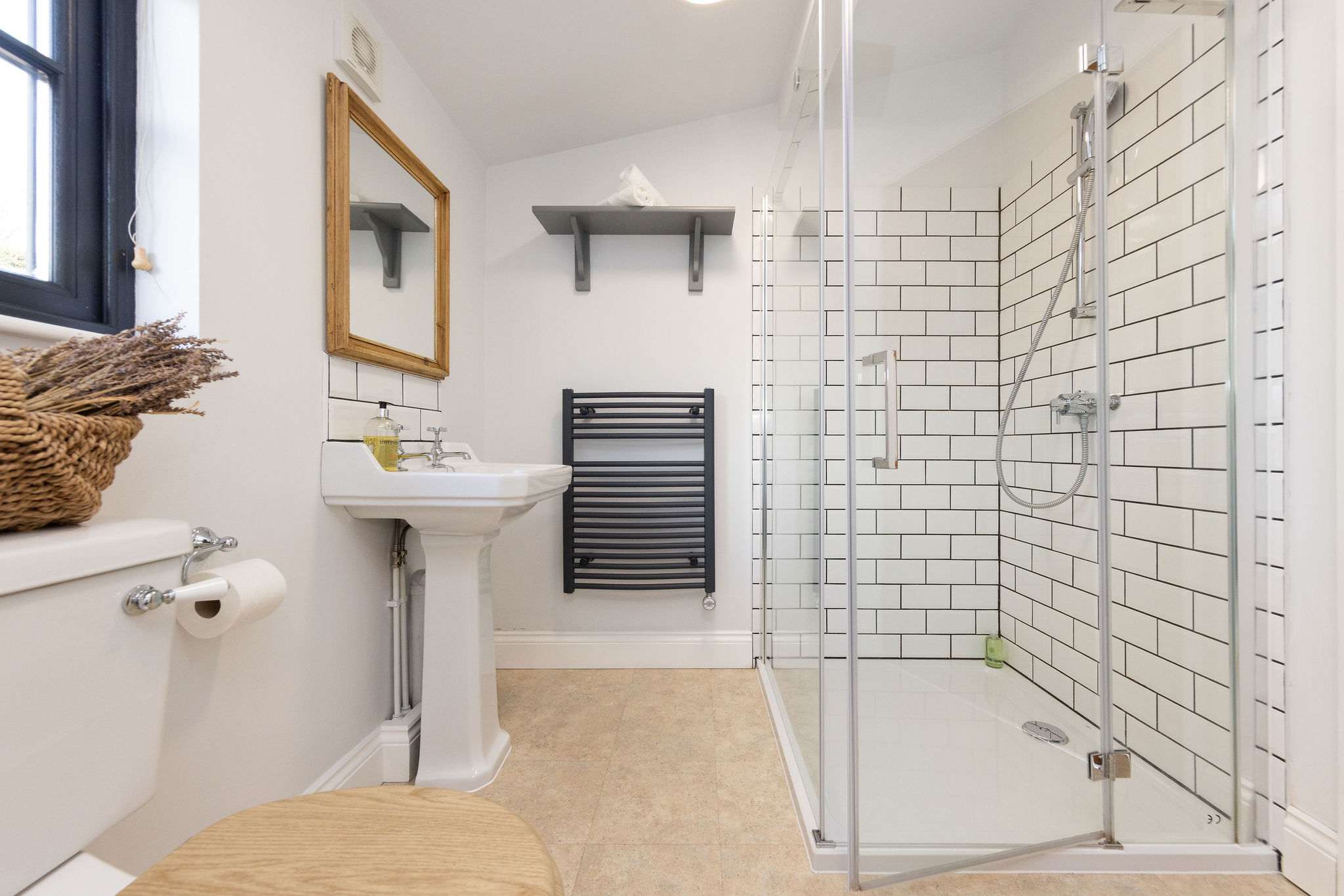 A walk in shower accompanies this bright and airy bathroom.