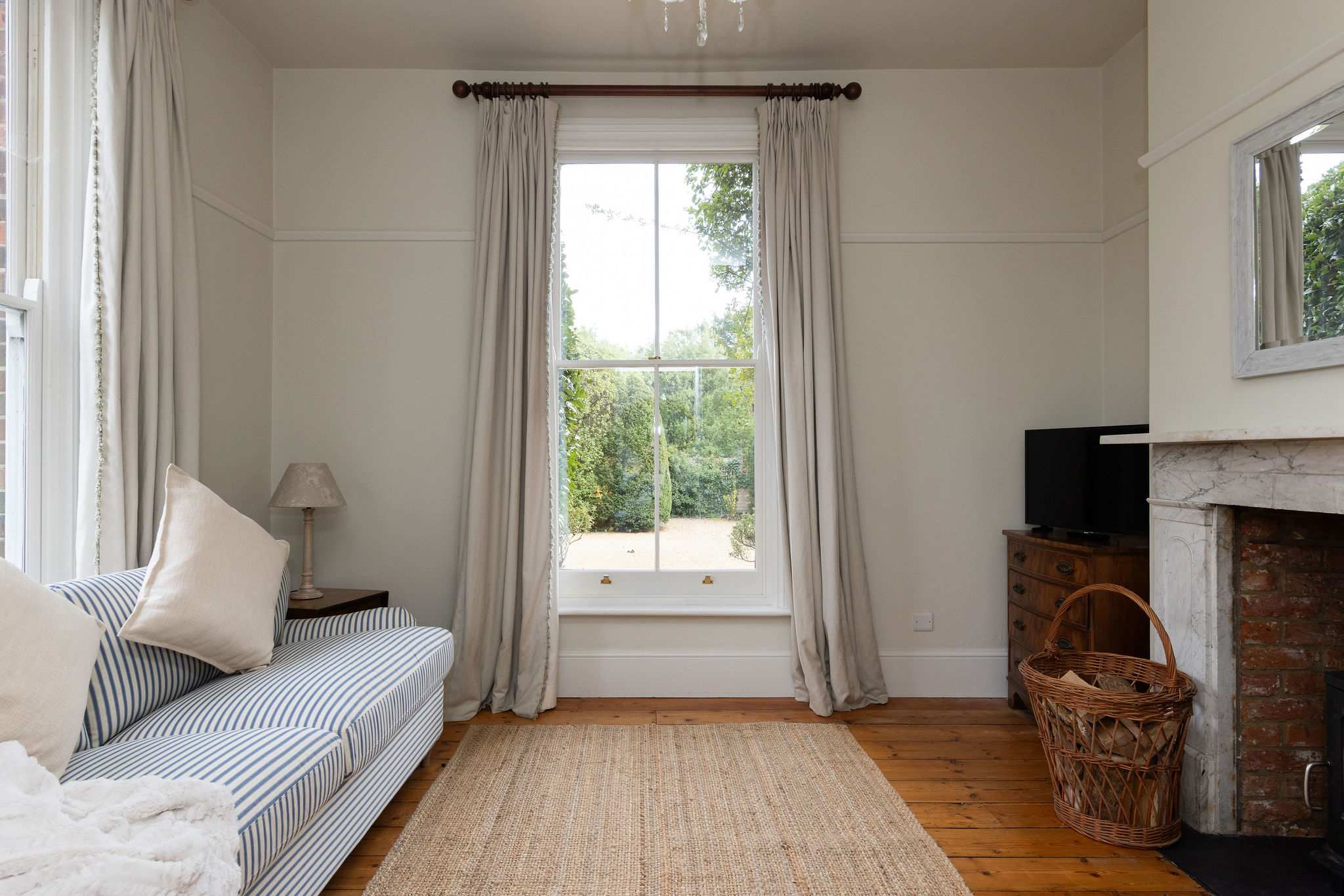 Bright sitting room with garden views and soft neutral tones