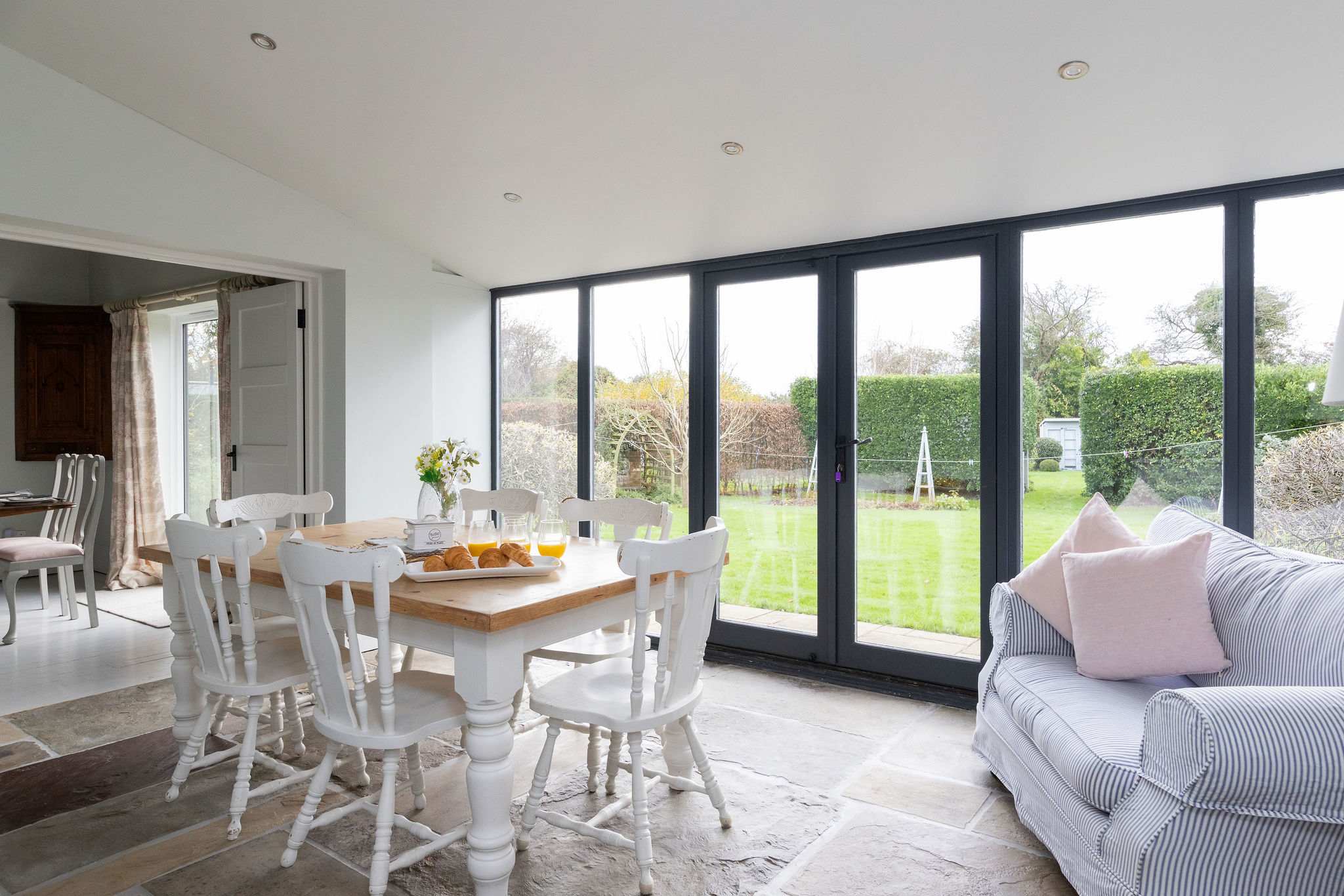 The open dining area with views of the large rear garden.