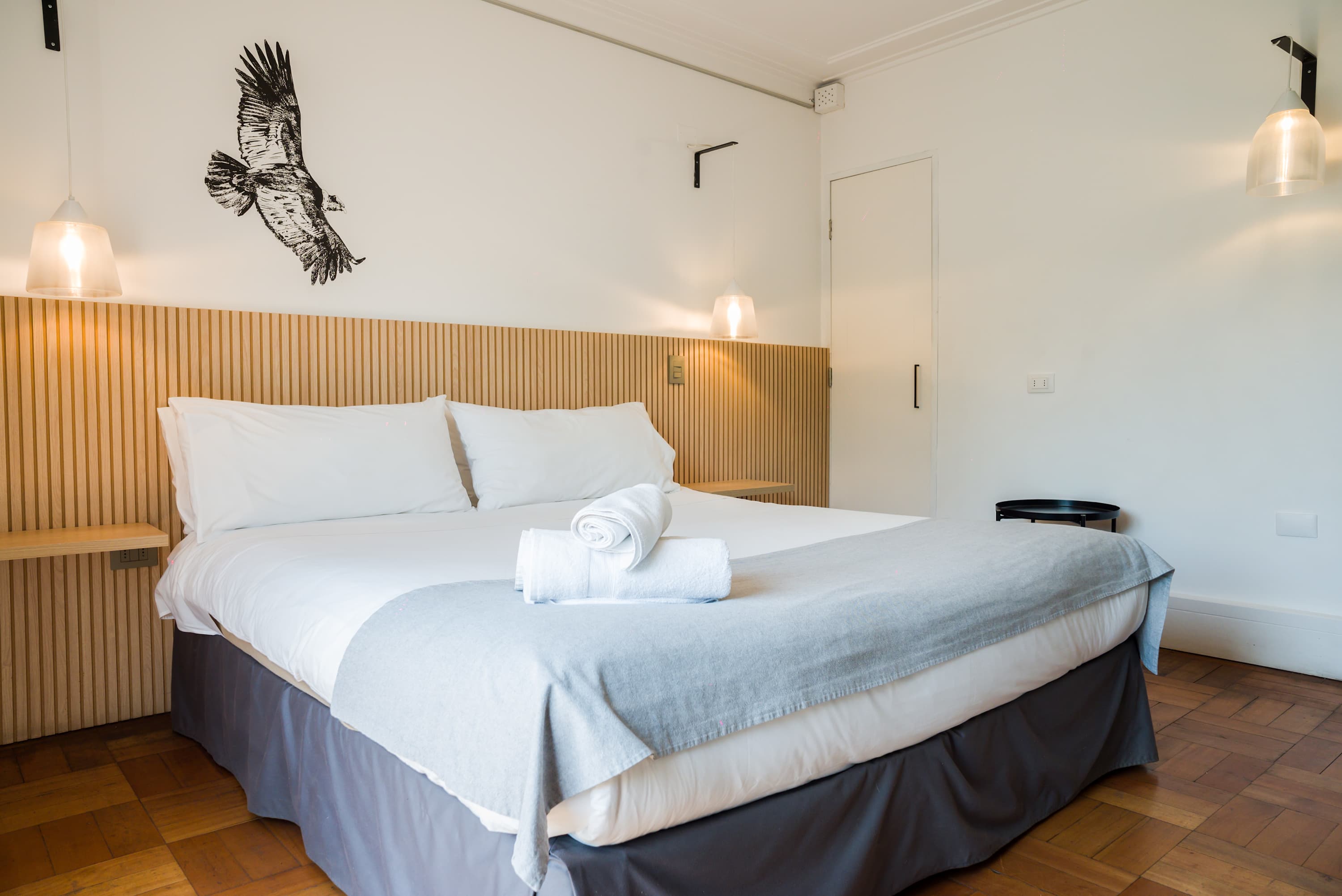 Relax in this cozy bedroom with modern decor and ambient lighting, perfect for a restful stay.