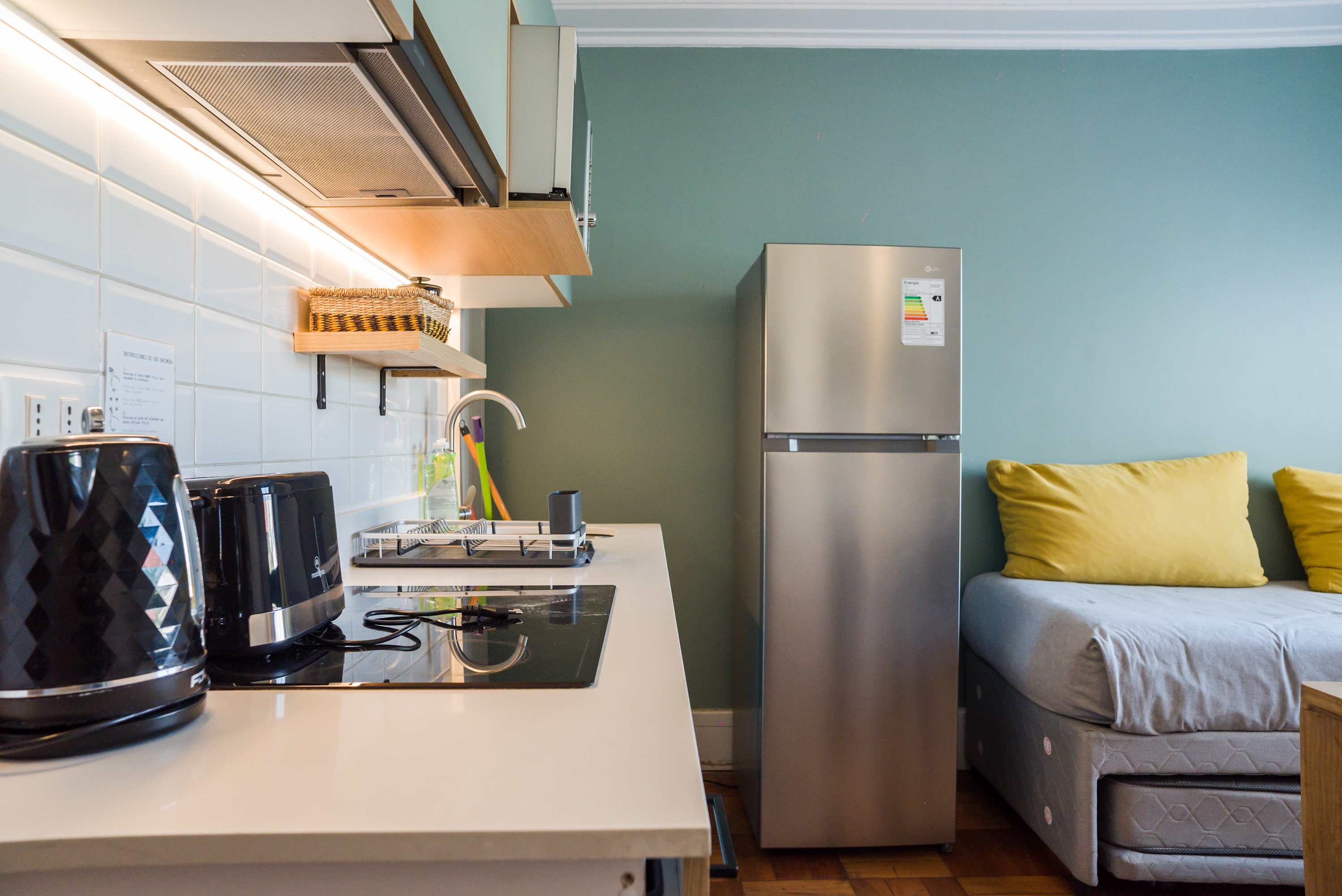 Modern kitchen with sleek appliances and cozy seating, perfect for a comfortable stay.