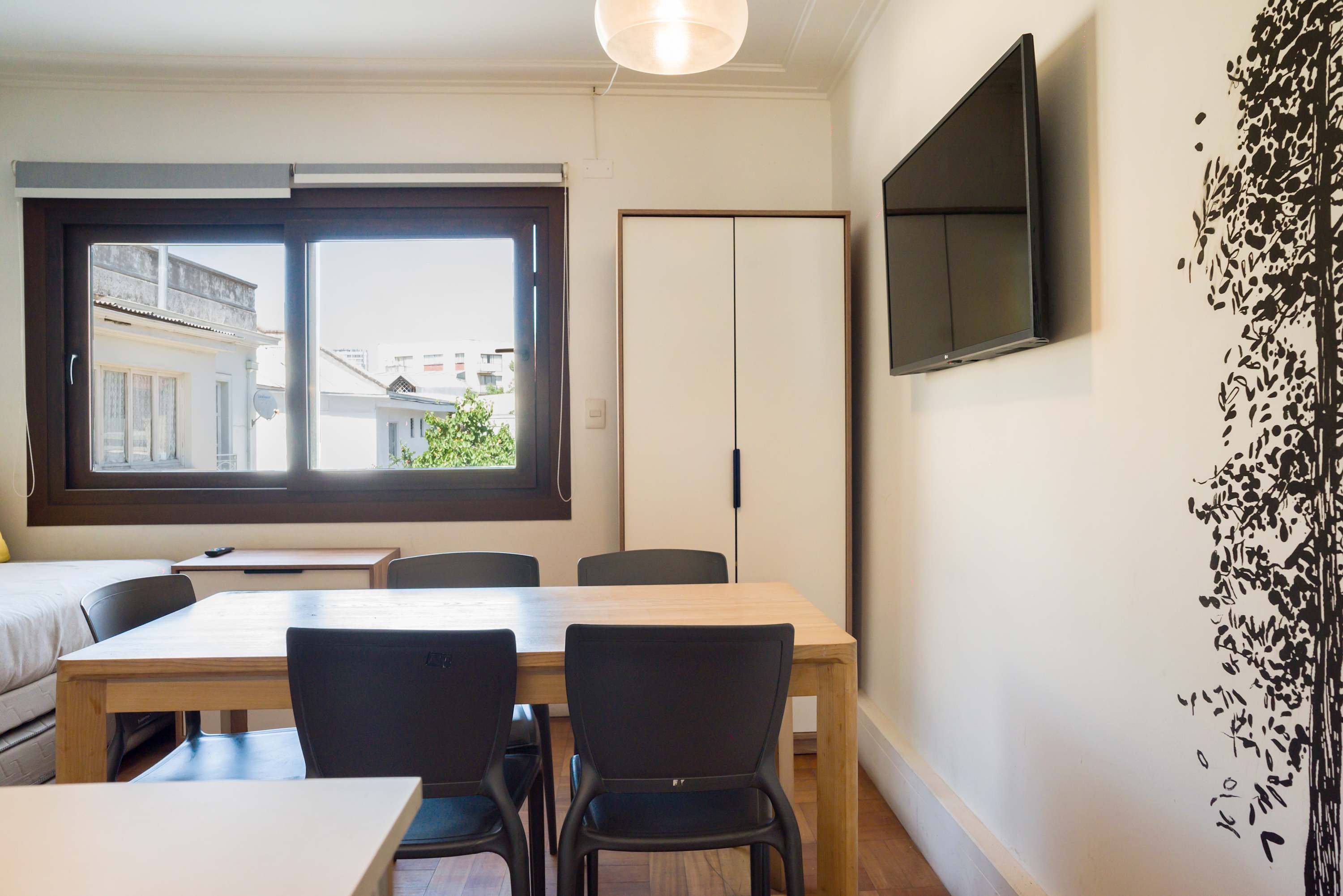 Bright and cozy living space with a large window and modern amenities, perfect for relaxation.