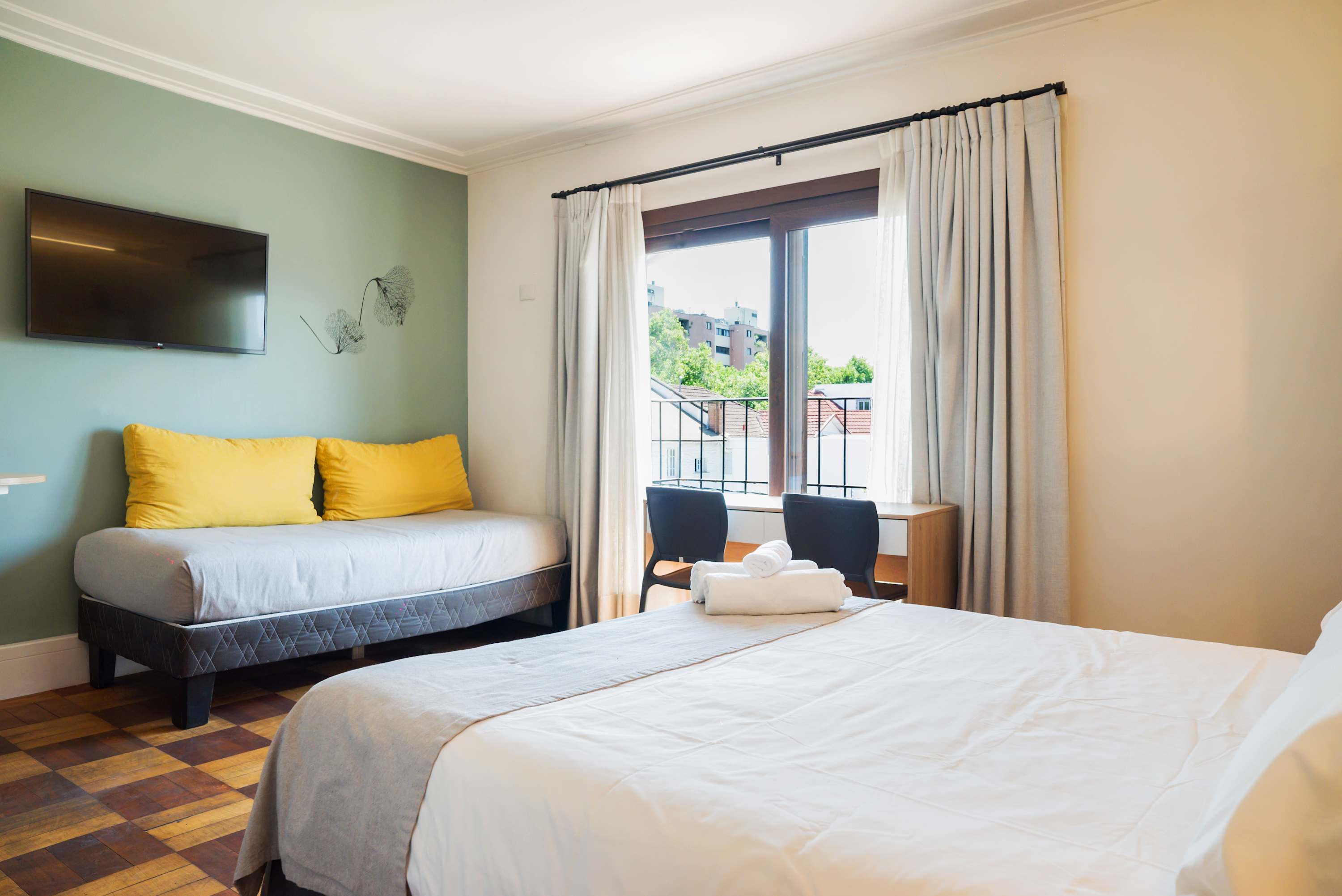 Cozy studio with natural light, comfy seating, and city views. Ideal for a relaxing stay.