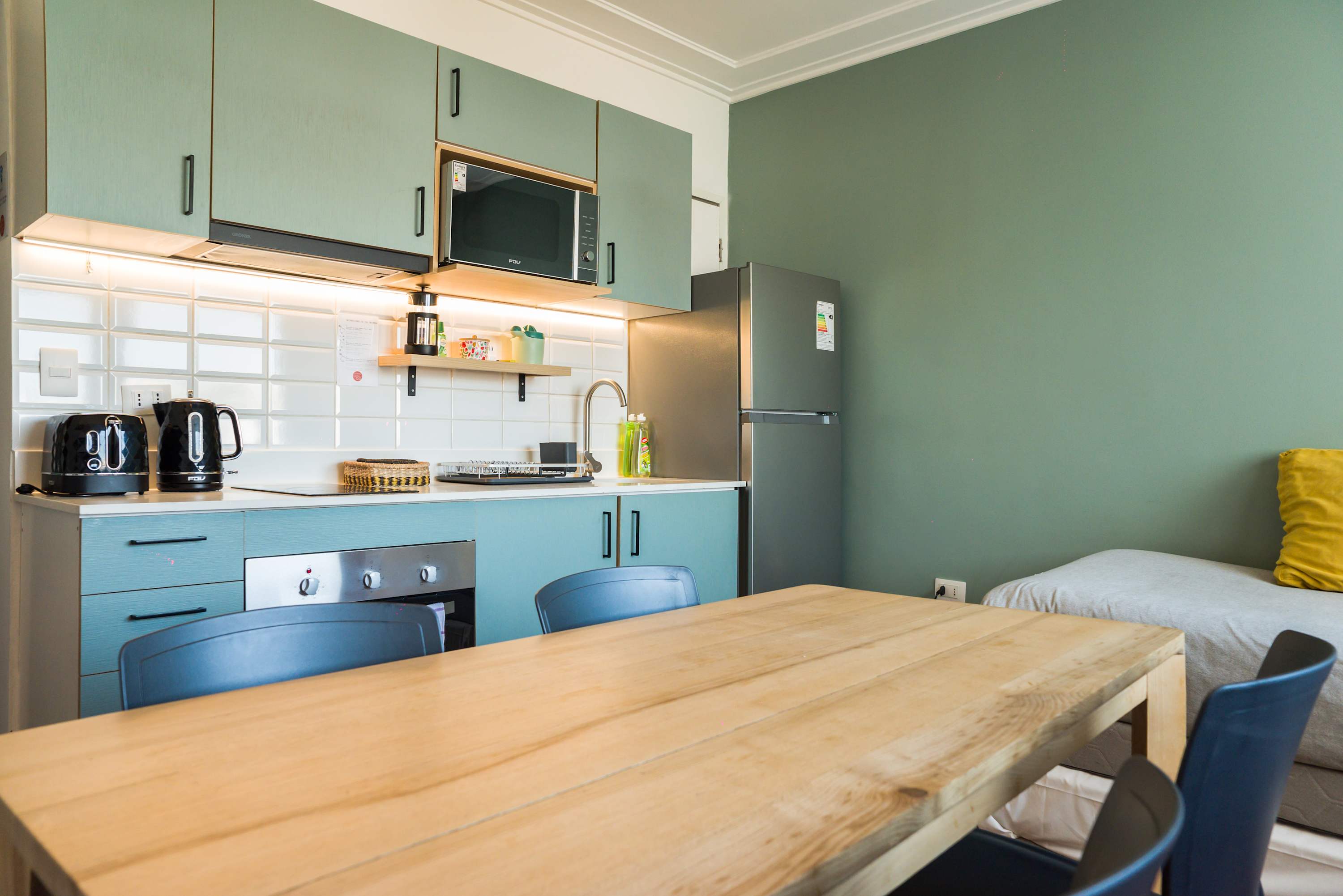 Charming studio kitchen with modern amenities and cozy dining area, perfect for a relaxing stay in the heart of Chile.