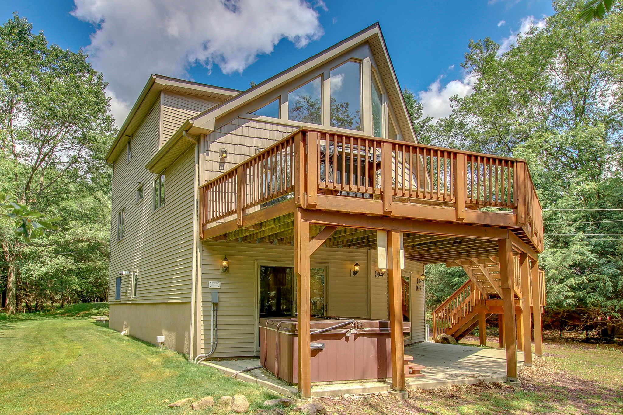 Take in the classic A-frame chalet with wraparound deck and wooded backdrop