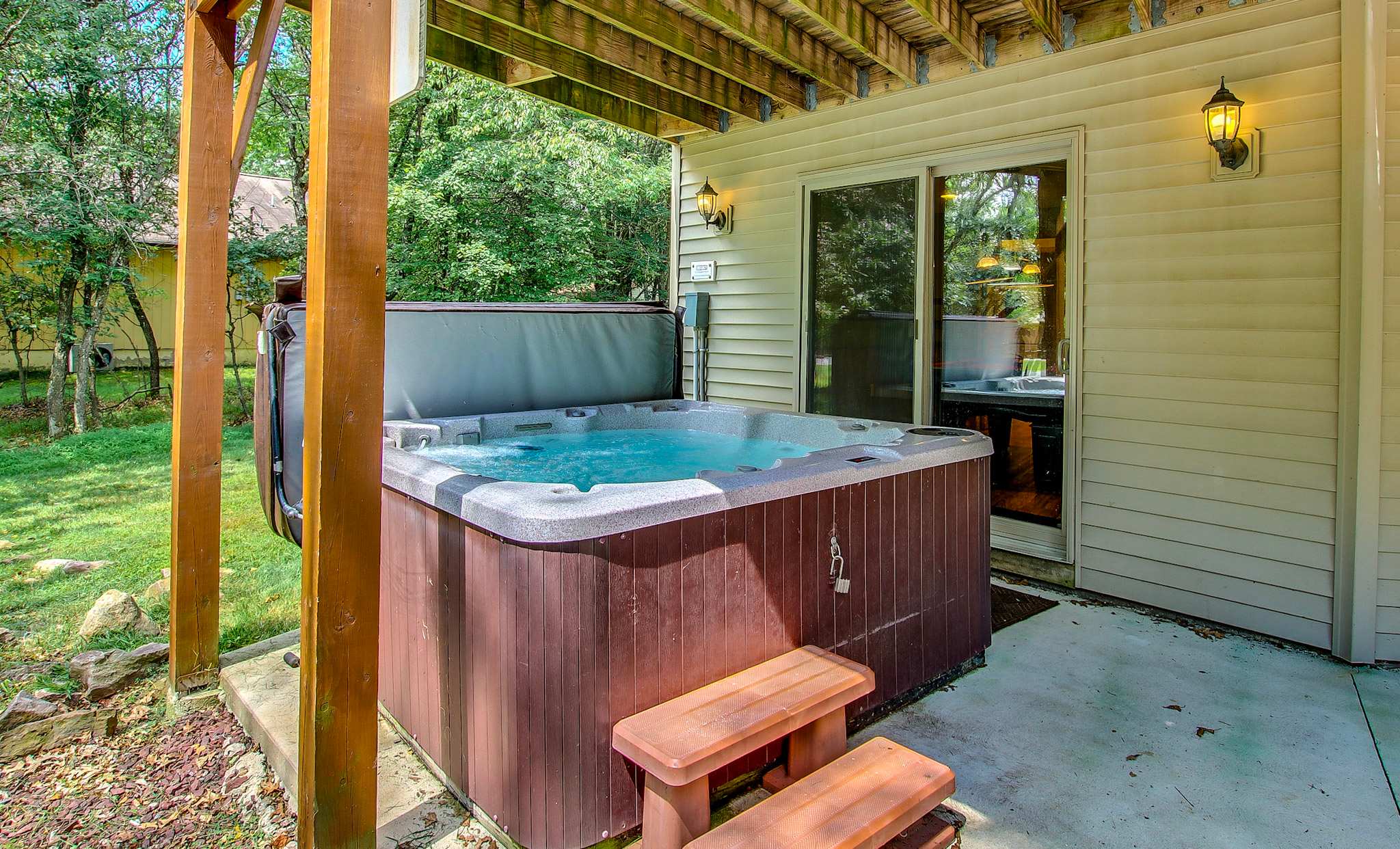 Unwind in the hot tub under the stars, surrounded by peaceful wooded views