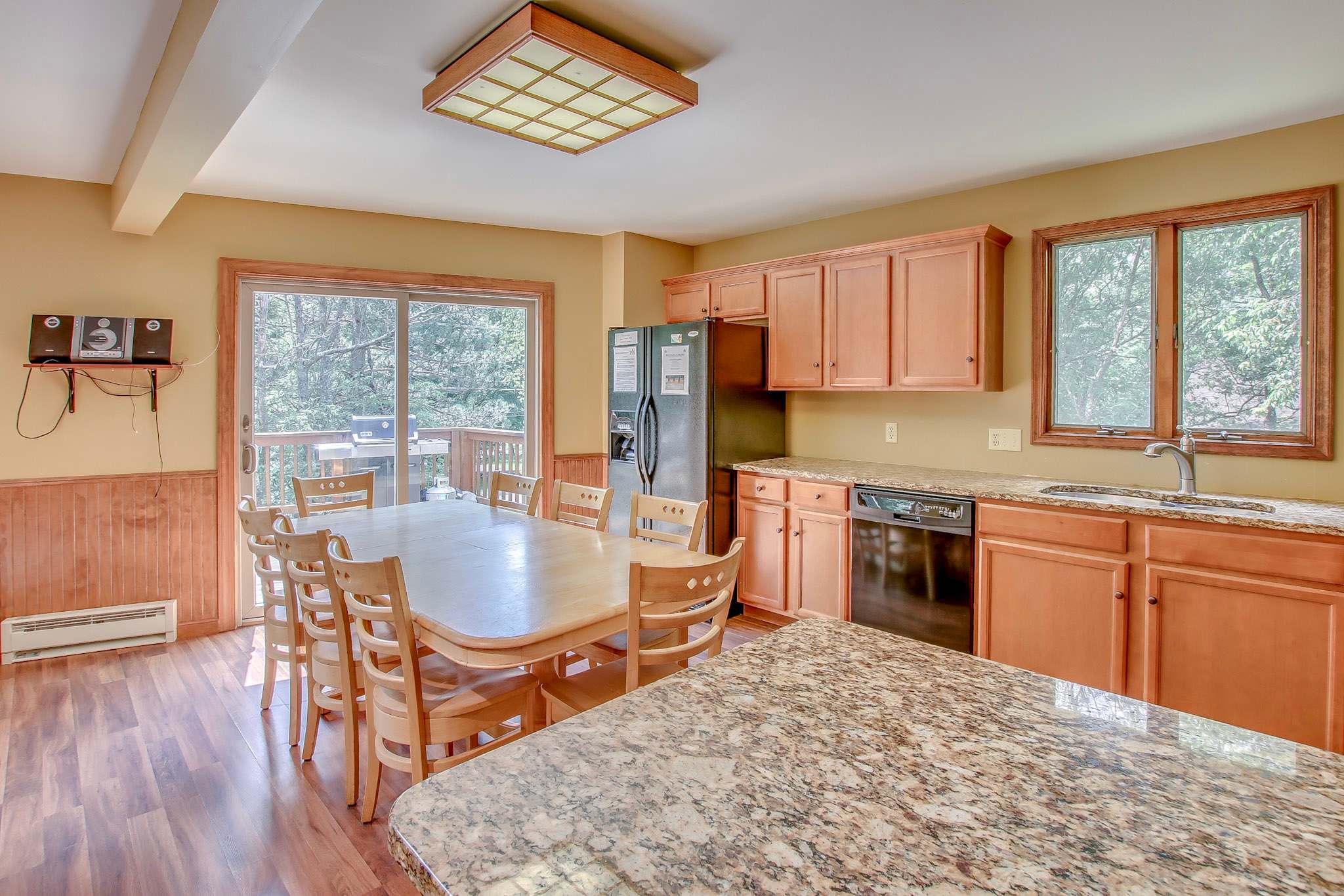 Kitchen with modern appliances opens to the dining and living areas